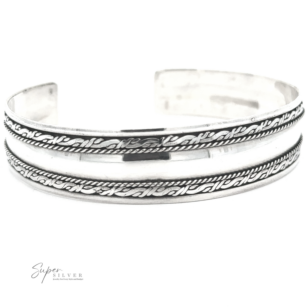 A handmade Silver Domed Cuff with Rope Pattern featuring two parallel engraved lines and a rope pattern in between. The brand 