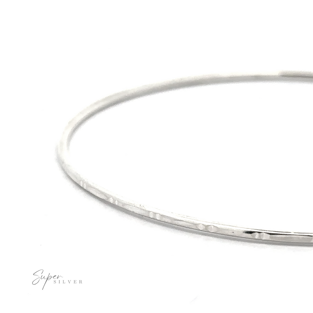 
                  
                    A simple, thin Delicate Faceted Cut Bangle Bracelet displayed on a white background with the words "Super Silver" in the bottom left corner.
                  
                