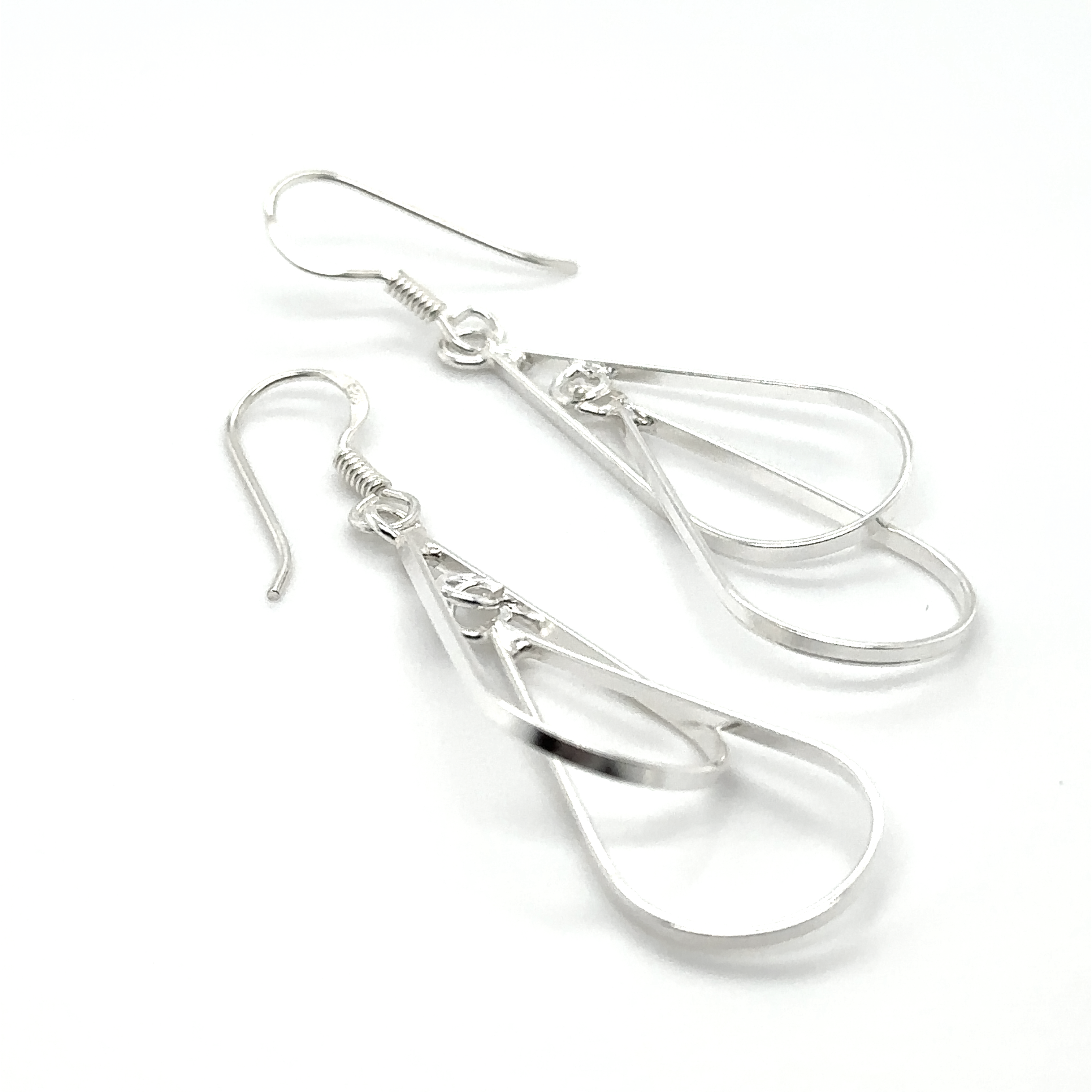 A pair of Super Silver Double Wire Teardrop Earrings with a swinging teardrop shape, placed on a white surface.
