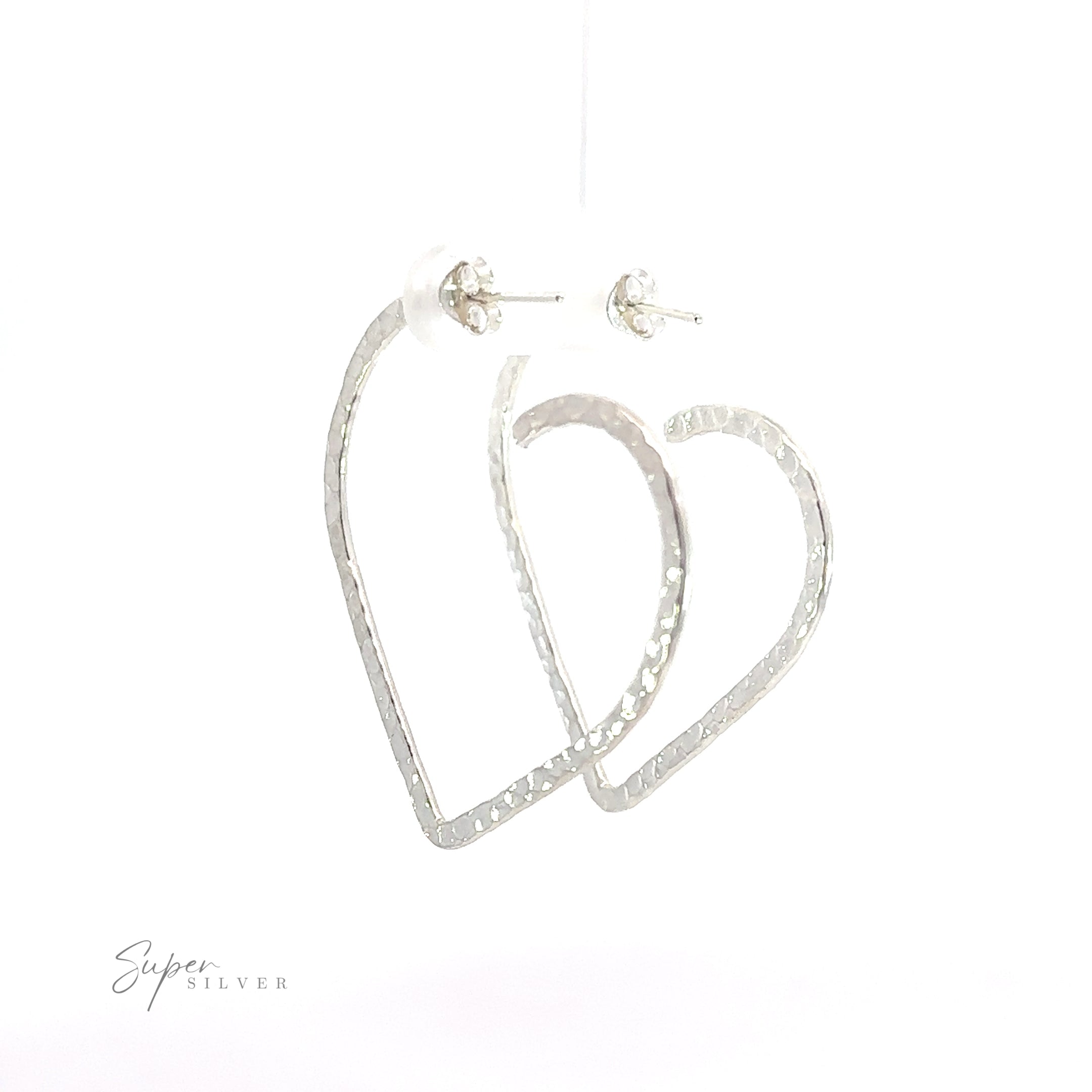 A pair of Textured Heart Hoop Earrings, made from .925 sterling silver, hanging on a white background.