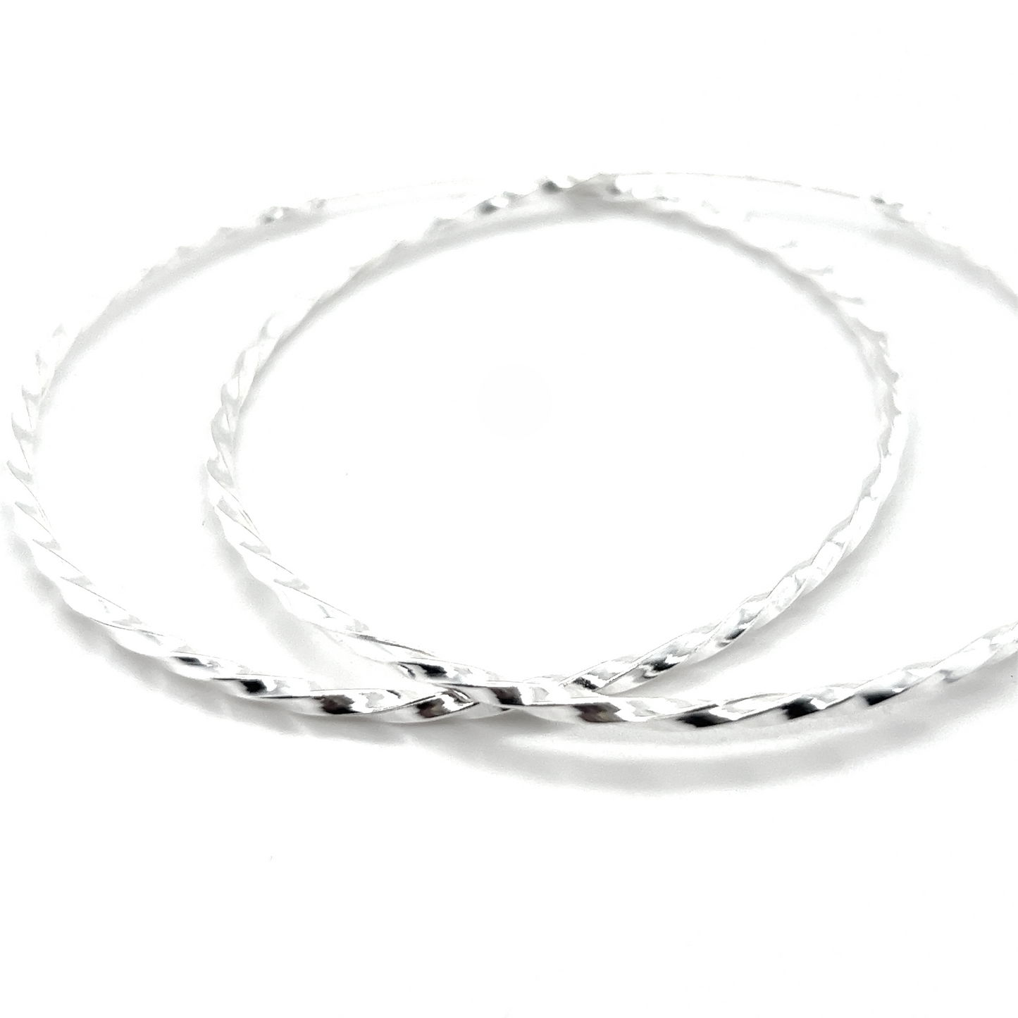 Two intertwined sterling silver 70mm Twisted Hoops on a white background.
