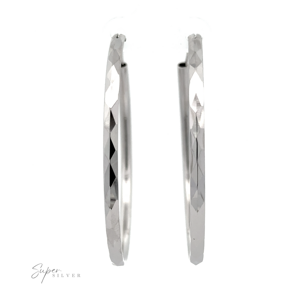 A pair of polished 3mm Thick Rhodium Finished Diamond Faceted Hoops with a sparkling diamond-faceted design displayed against a white background, with the text "Super Silver" in the lower left corner.