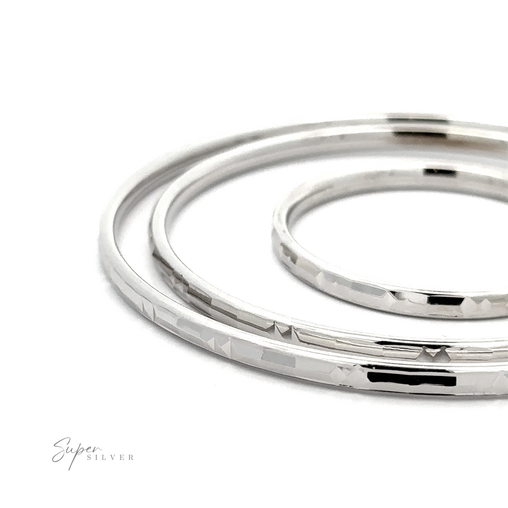 Three stacked Modern 3mm Rhodium Finish Facet Hoops, displayed against a white background with a logo "super silver" in script.