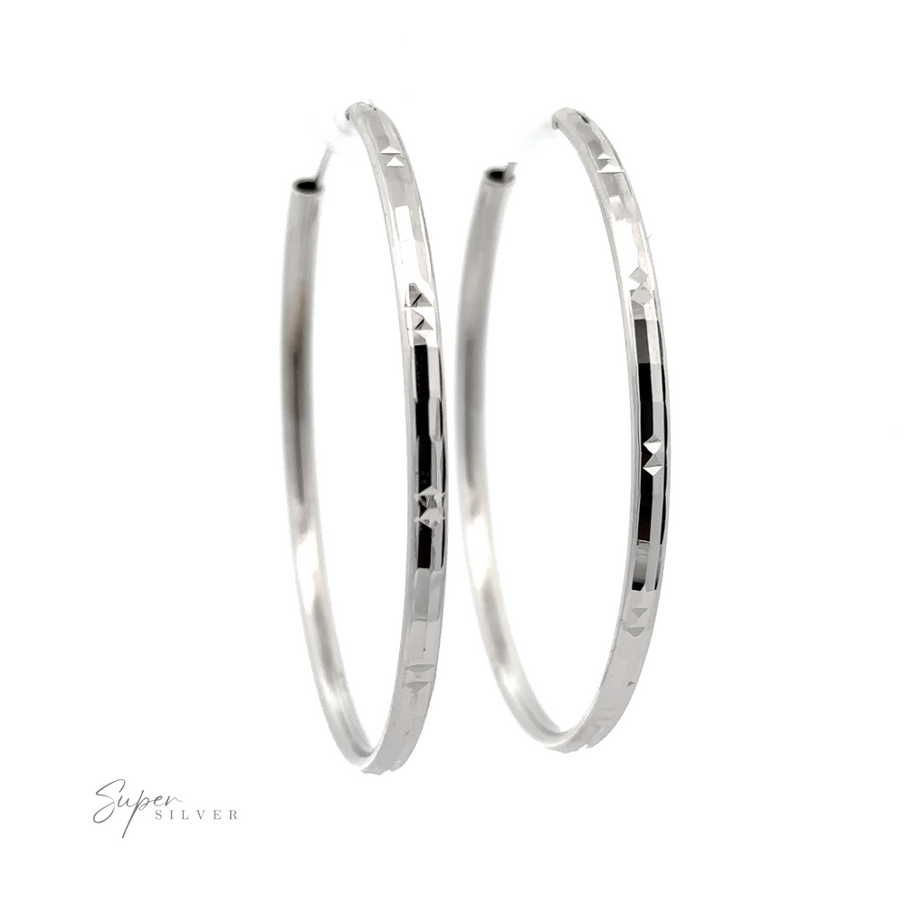A pair of Modern 3mm Rhodium Finish Facet Hoops with engraved details, displayed against a white background with the logo "super silver.