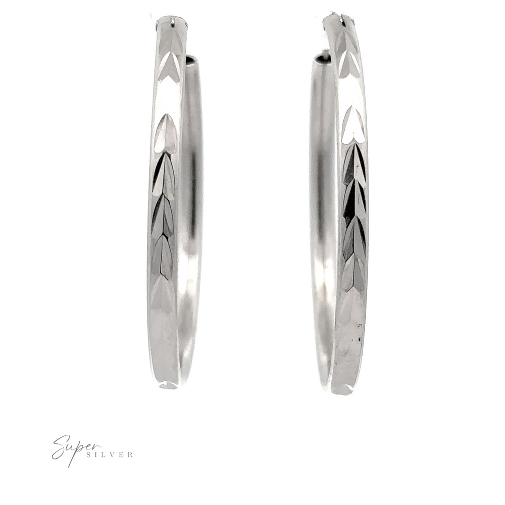 A pair of 3mm Chevron Faceted Hoops with etched leaf designs, isolated on a white background with a "super silver" signature.