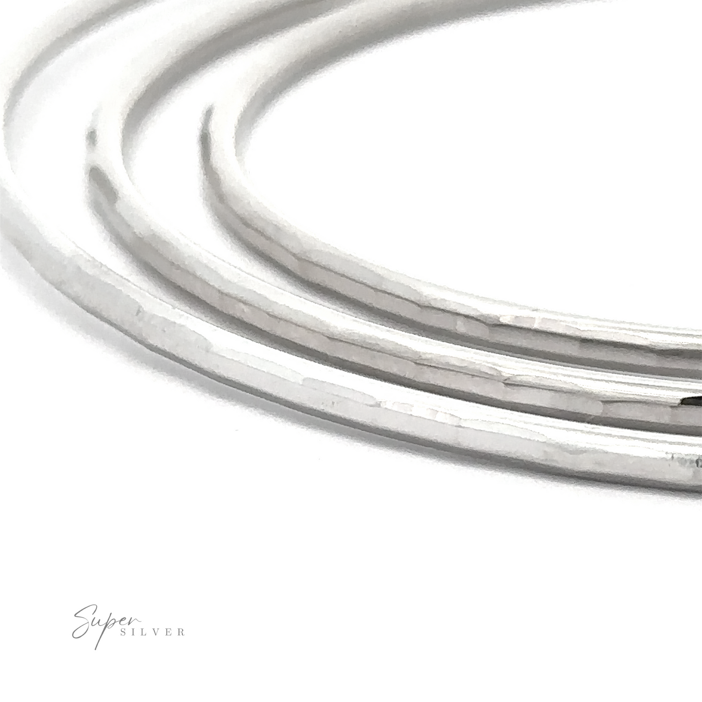 Close-up of four 2mm Diamond Cut Hoop Earrings with a rhodium finish, displayed on a white surface with the text "super silver" in elegant script.