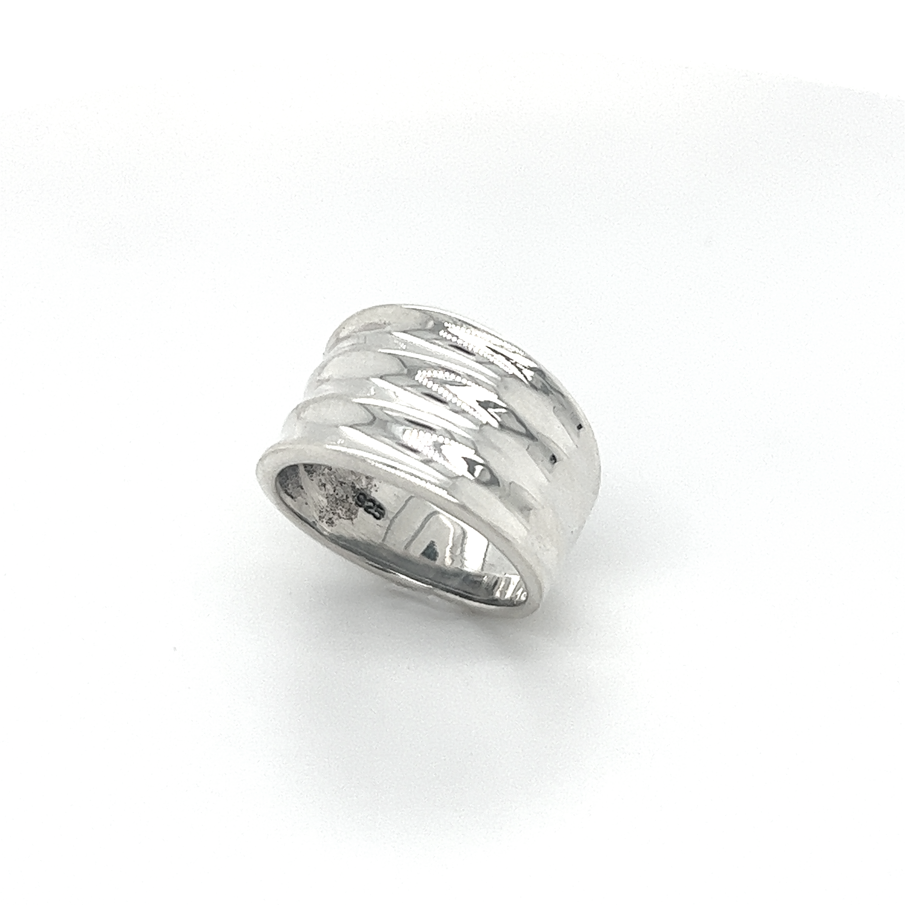 A textured Super Silver Wide Tapered Band ring with a fashionable design.