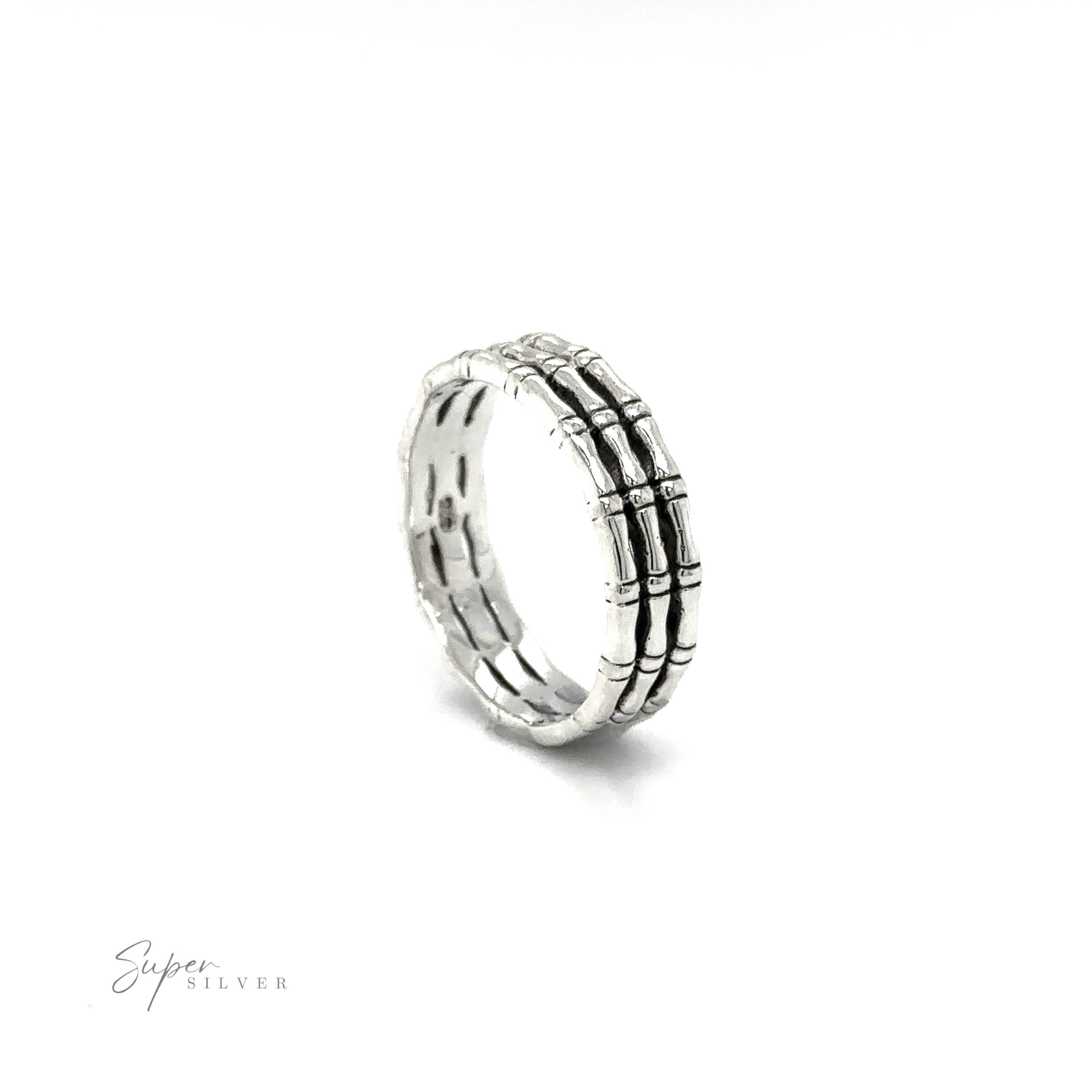 A minimalist style Triple Bamboo Band Ring with black and white stripes on a white background made by Super Silver.