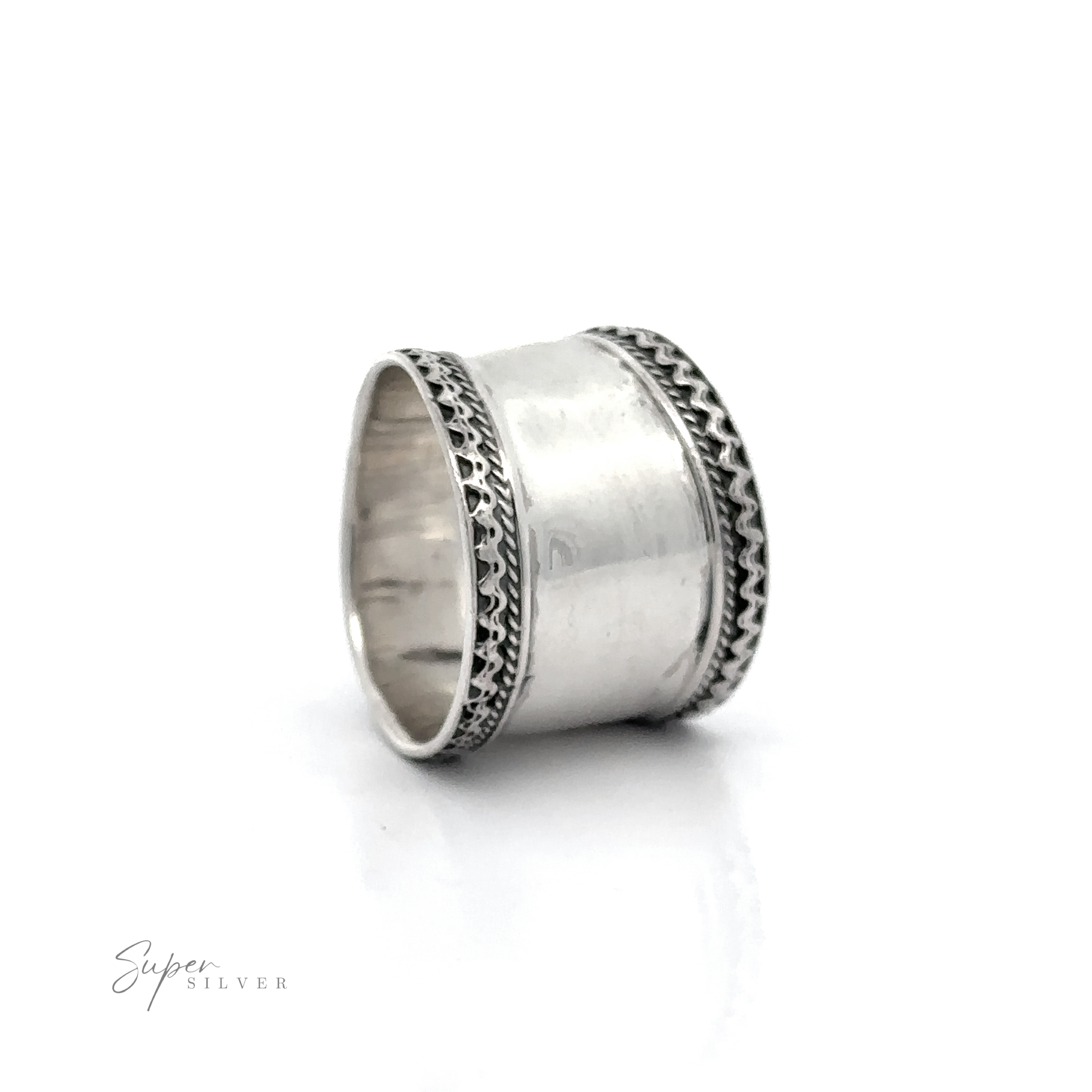 A sterling silver ring with diamonds on a Wide Silver Band with Etched Border.