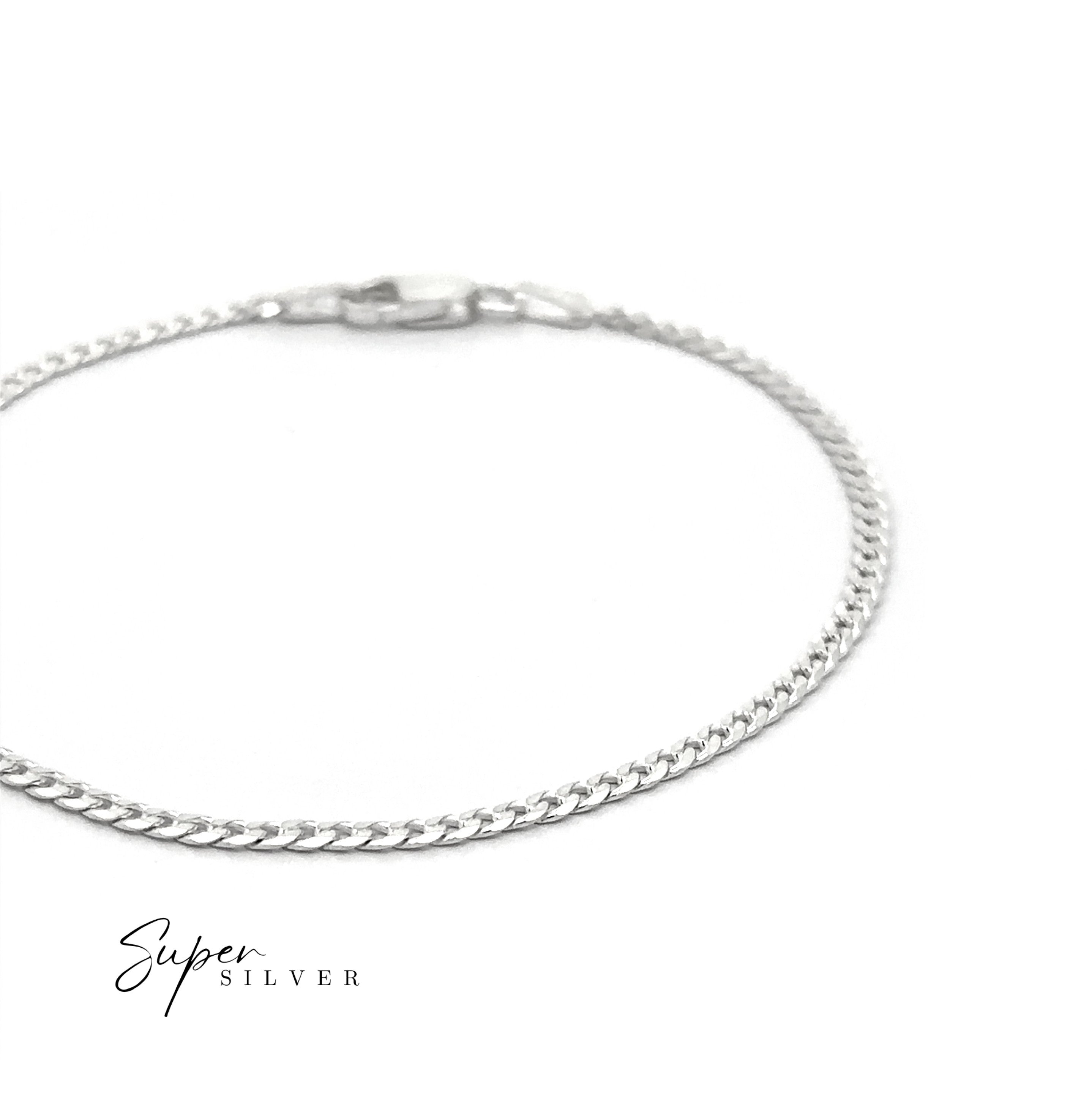 A Thin Italian Curb Chain sterling silver bracelet with a clasp is displayed on a white background. “Super Silver” appears in the lower left corner.
