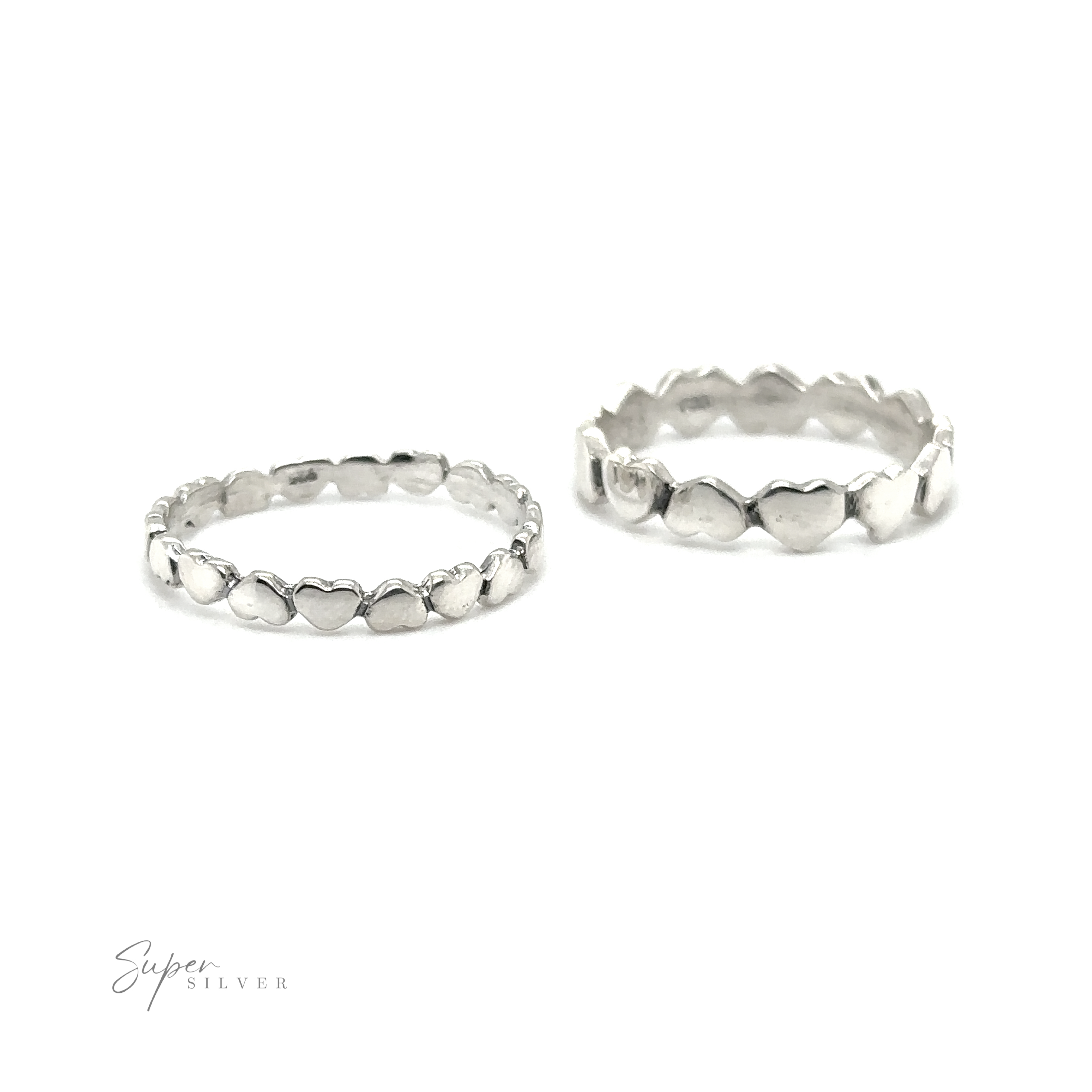 Two sterling silver rings with Hearts Band With Alternating Pattern, perfect for stacking.