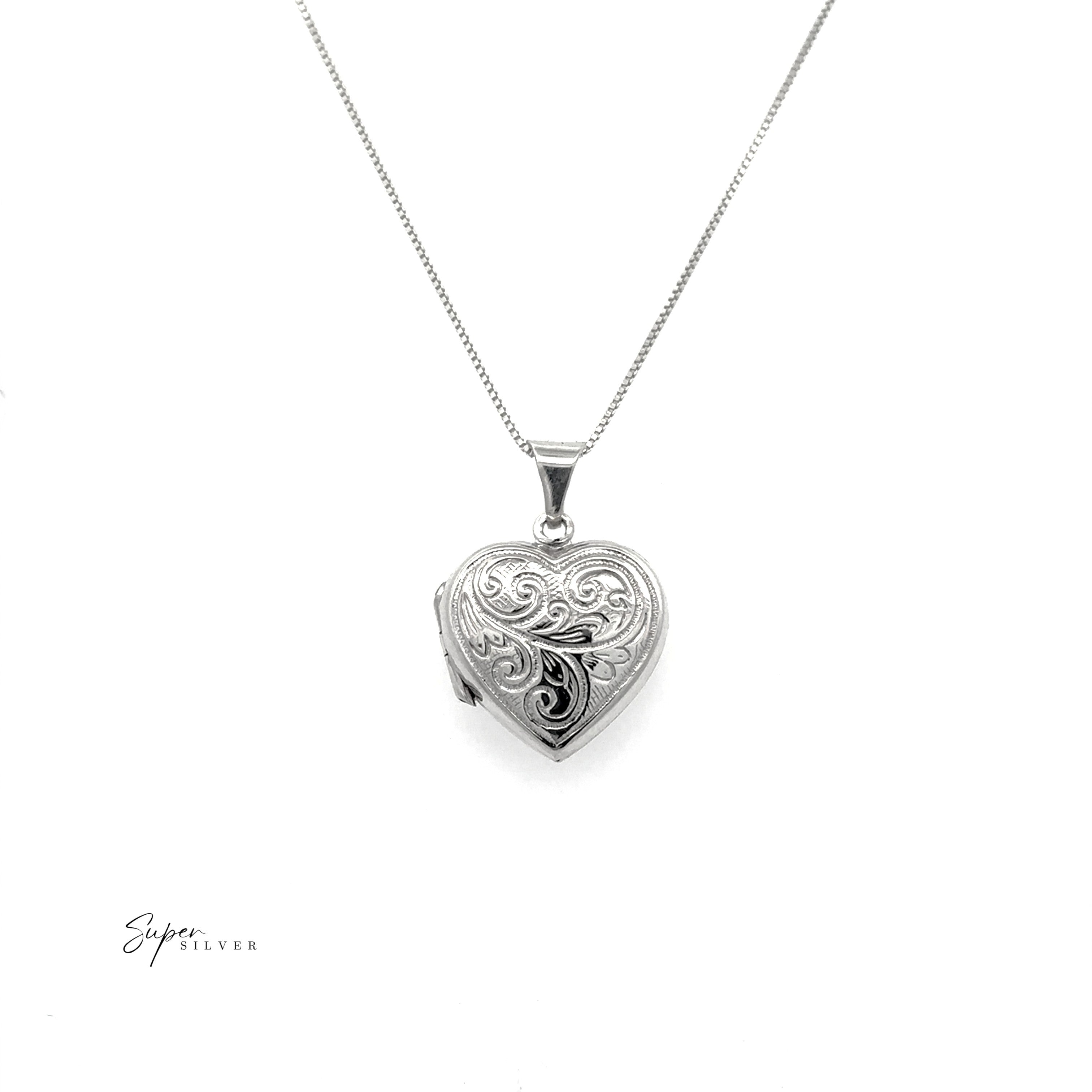The Timeless Heart Locket is a vintage-inspired sterling silver heart-shaped locket with an intricate engraved design on a fine chain, shown against a white background.