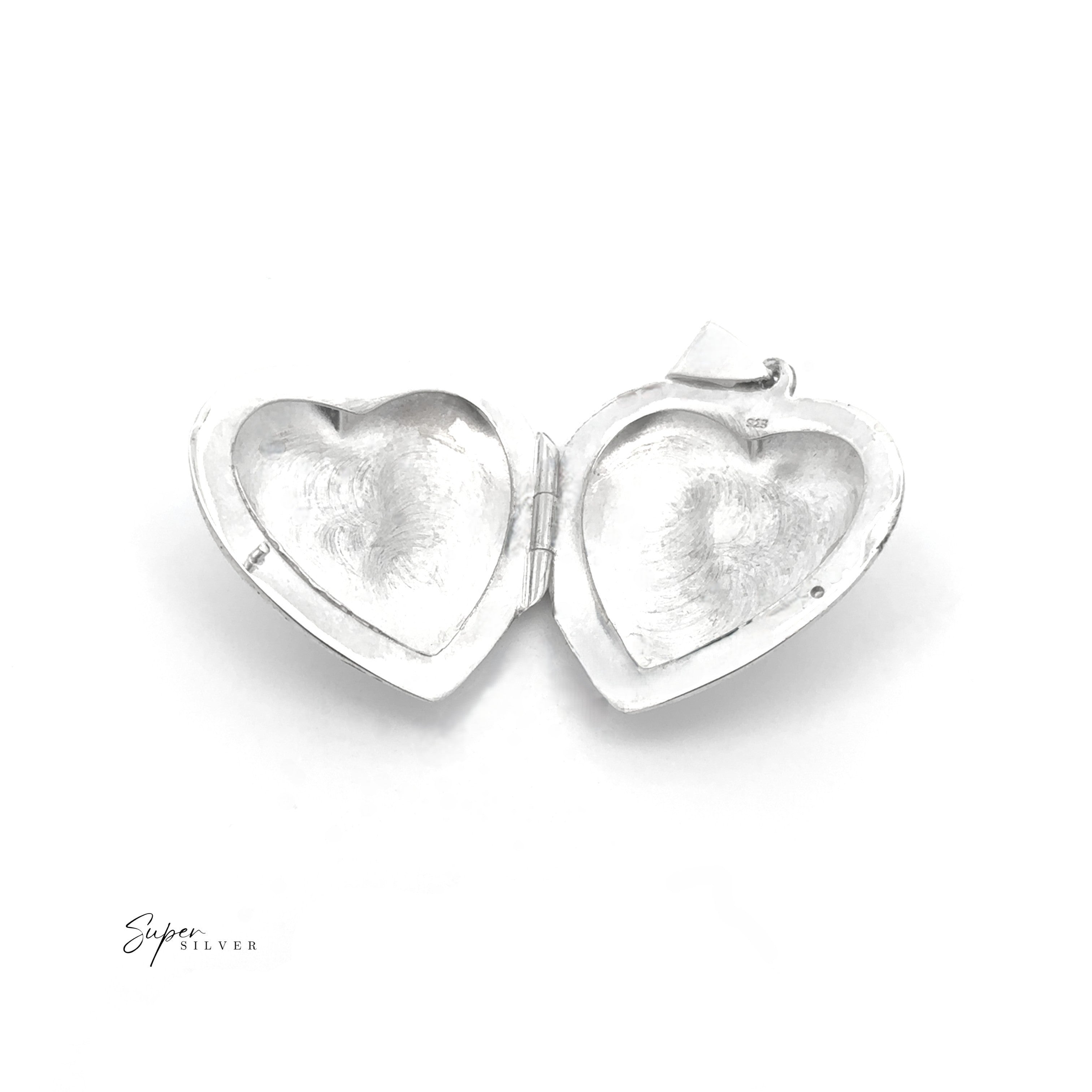 A Heart Locket with Filigree Border in sterling silver, featuring open empty compartments, is displayed on a white background.