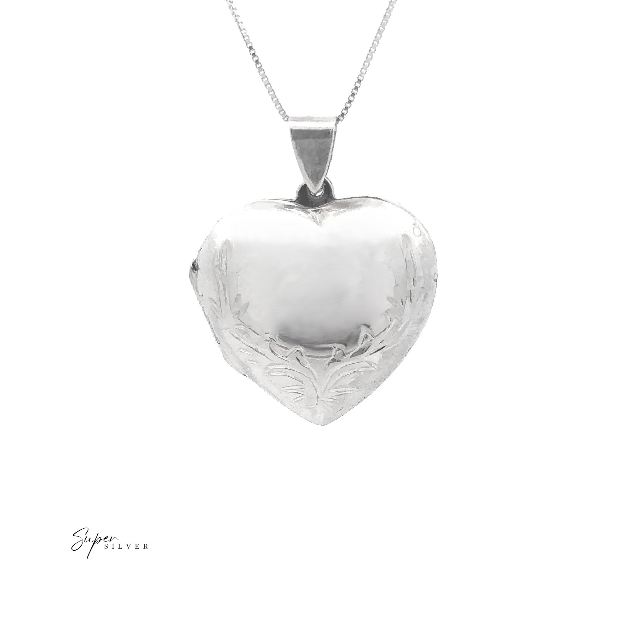The Heart Locket with Filigree Border, crafted in sterling silver with delicate engraved details, hangs on a fine chain against a white background.