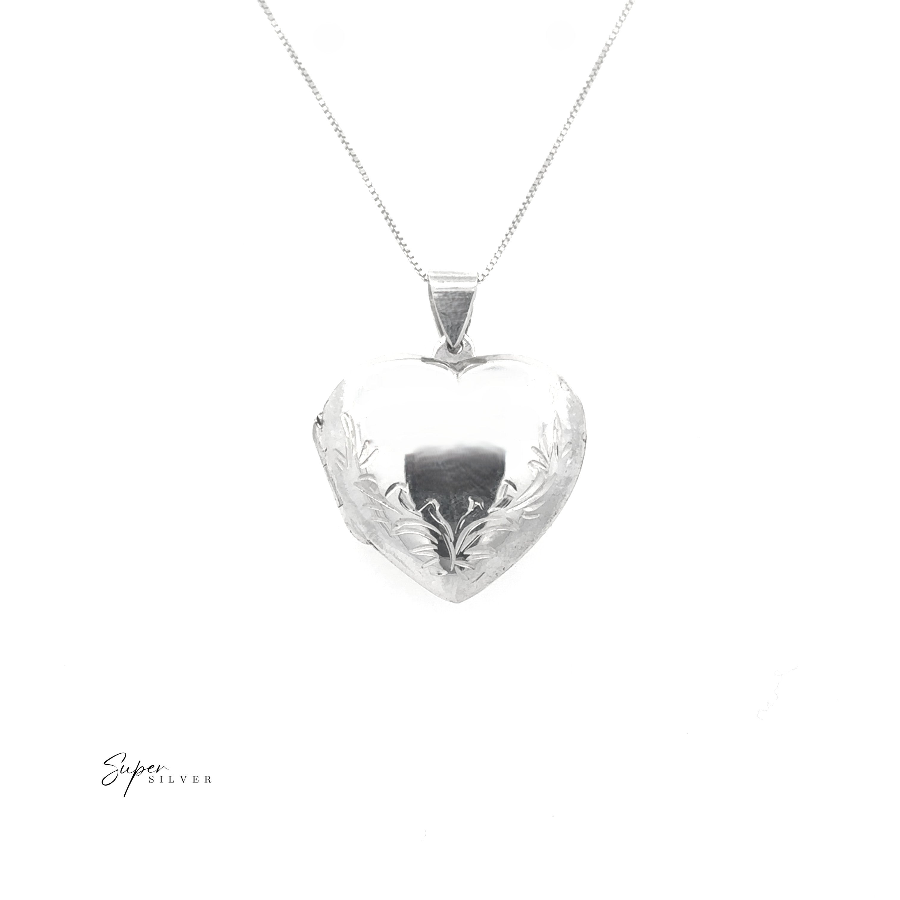 Heart Locket with Filigree Border in sterling silver, featuring an engraved floral design, displayed on a fine chain against a white background.