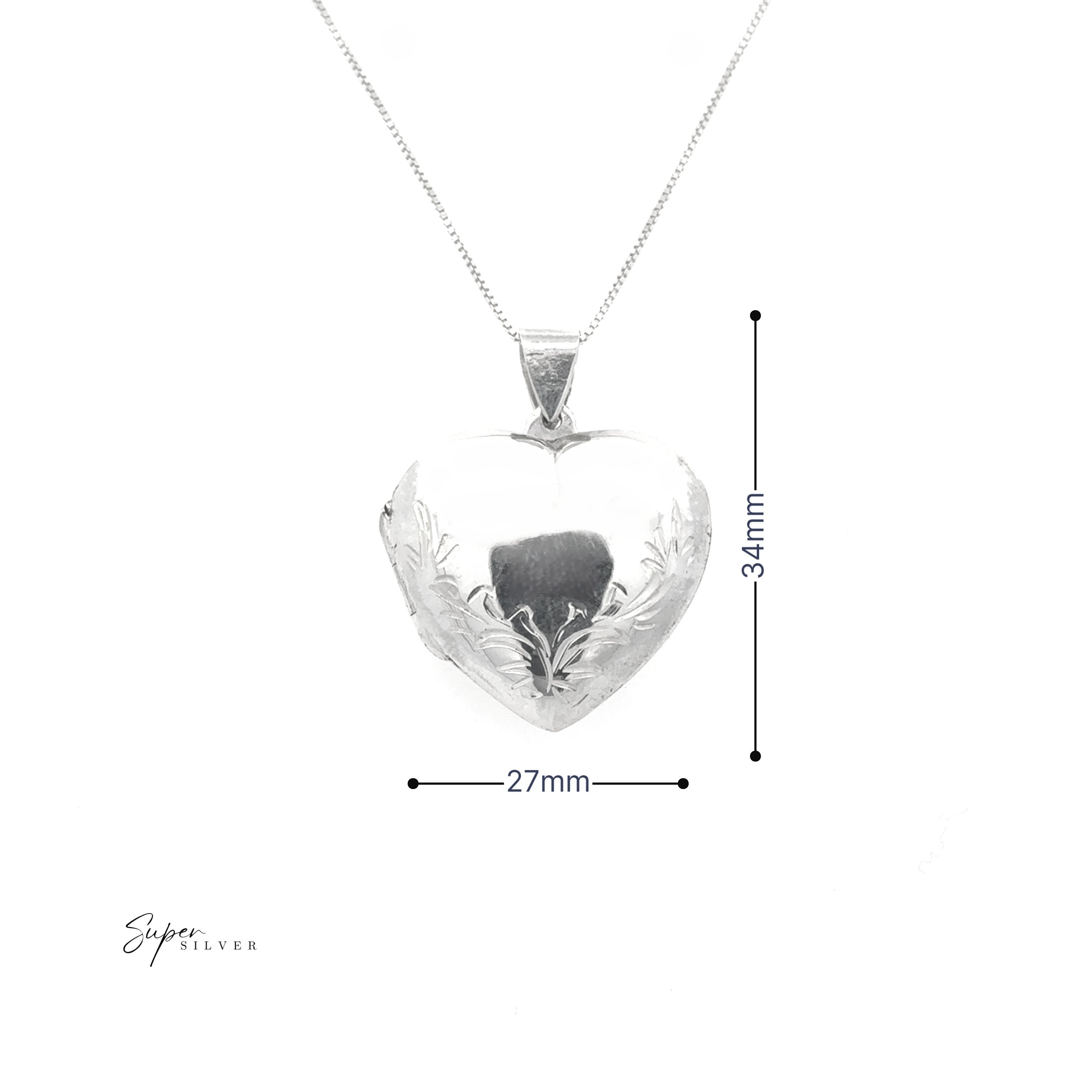 The Heart Locket with Filigree Border is a sterling silver, heart-shaped pendant featuring an engraved floral design, measuring 34mm tall by 27mm wide, and comes on a delicate chain.