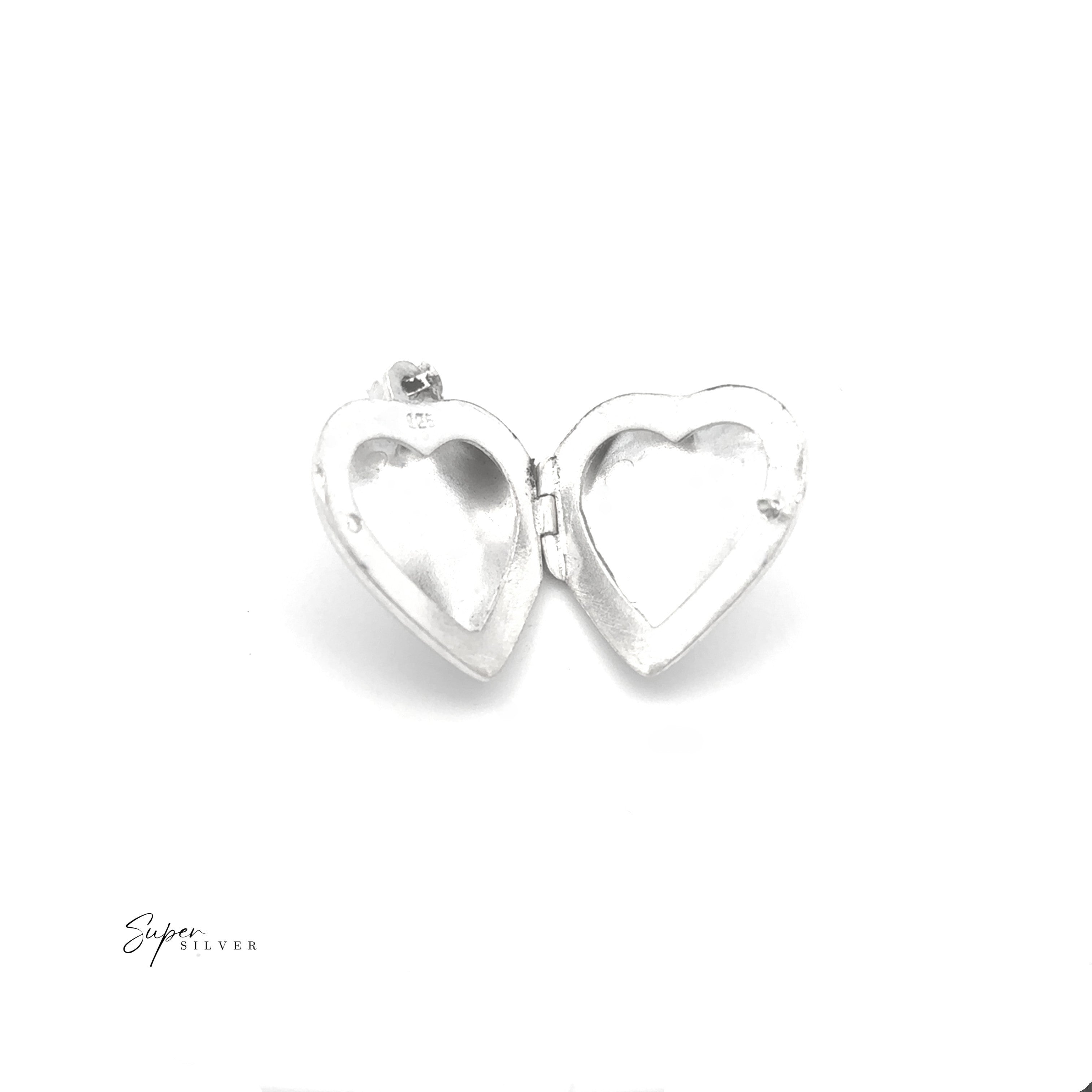 The Timeless Heart Locket in sterling silver is open to show its empty interior against a white background. "Super Silver" appears in the bottom left, emphasizing the vintage charm of this elegant piece.