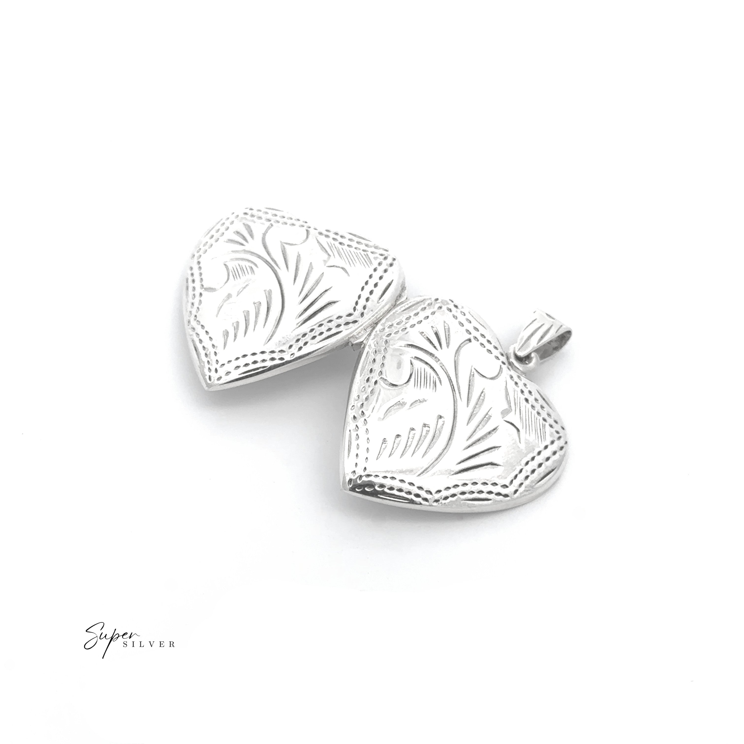 The Timeless Heart Locket, crafted in sterling silver with engraved floral patterns and shown open on a white background, exudes vintage charm.