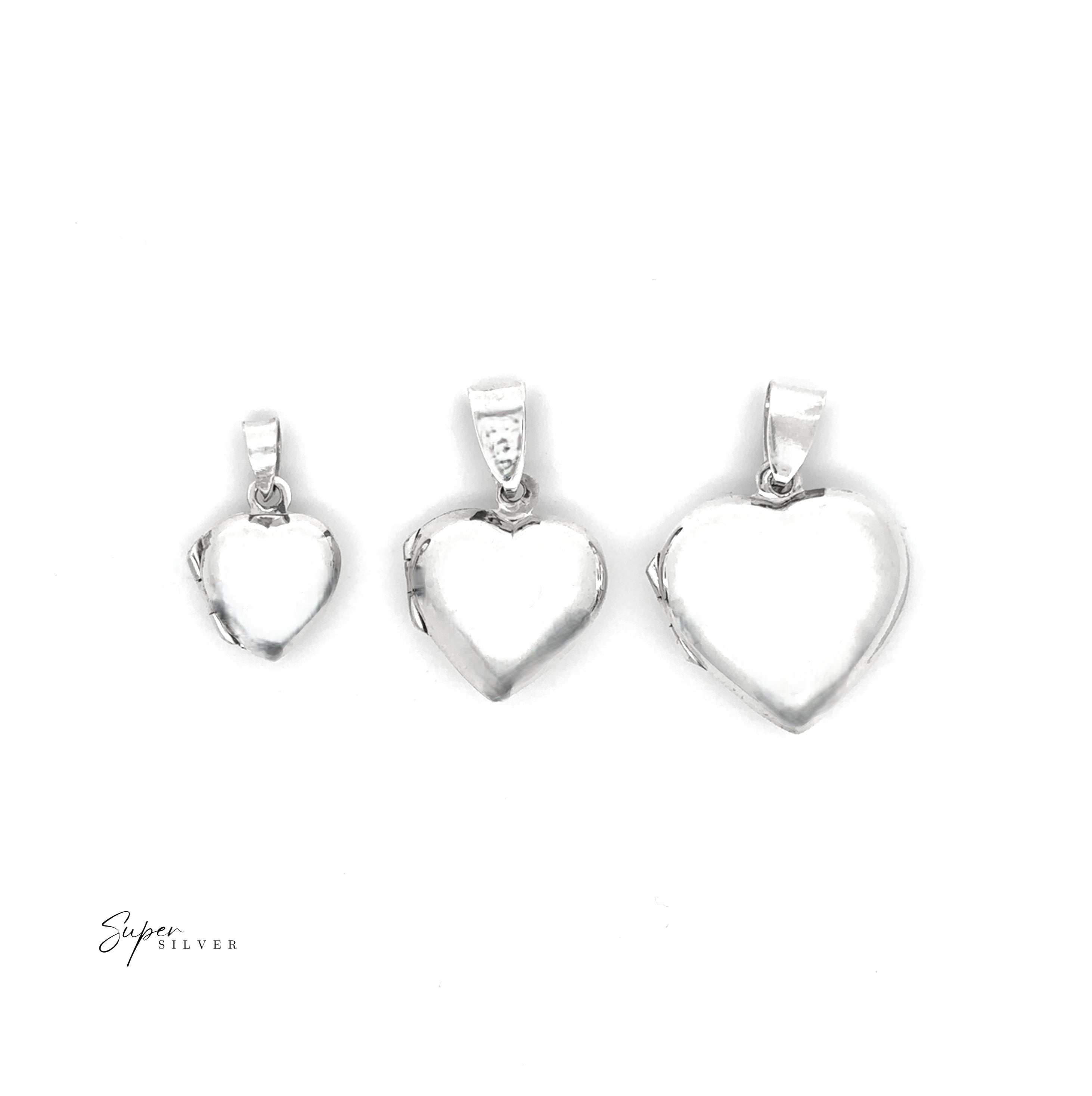 Three Plain Heart Lockets in silver, each a different size, are arranged in a row on a white background. The "Super Silver" logo is visible in the lower left corner, highlighting the charm of these timeless tribute lockets.