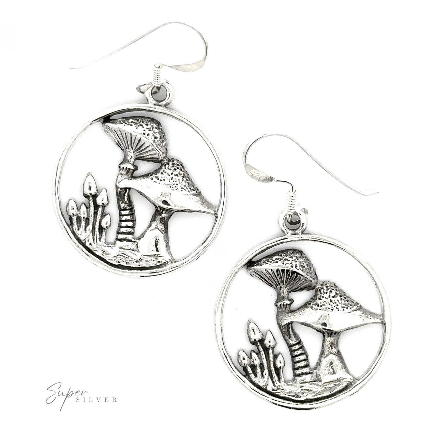 A pair of circular sterling silver earrings featuring intricate fungi and foliage designs, displayed against a white background with a signature "Trippy Encircled Mushroom Earrings" at the bottom.