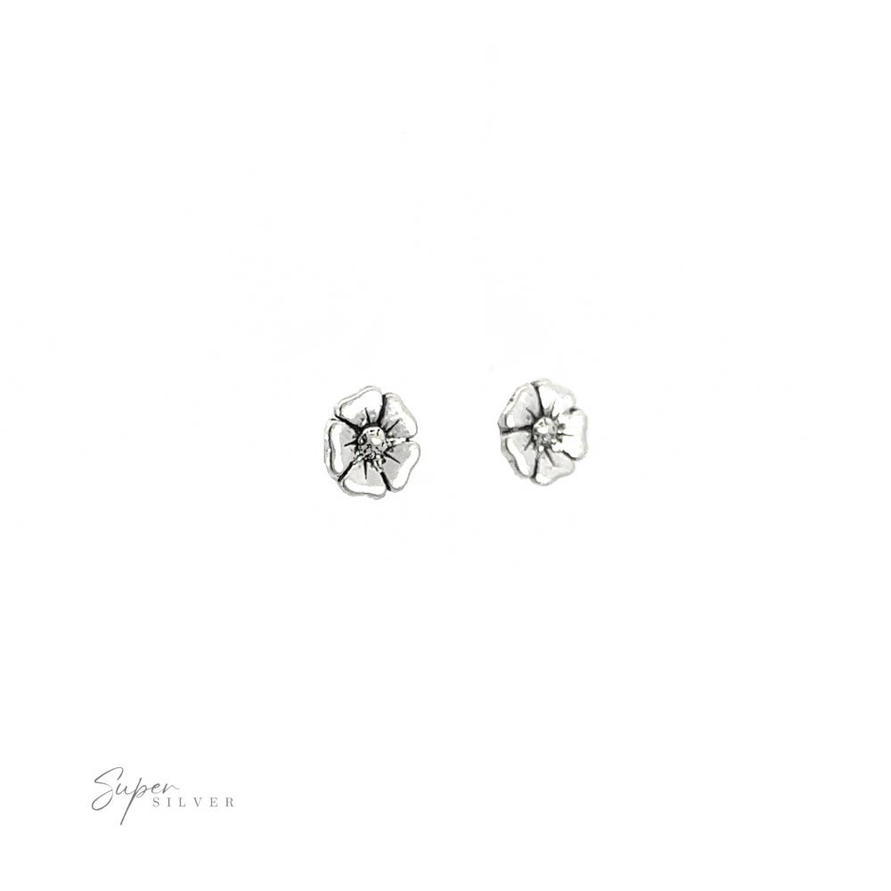 
                  
                    A pair of adorable silver Poppy Flower Studs on a white background.
                  
                