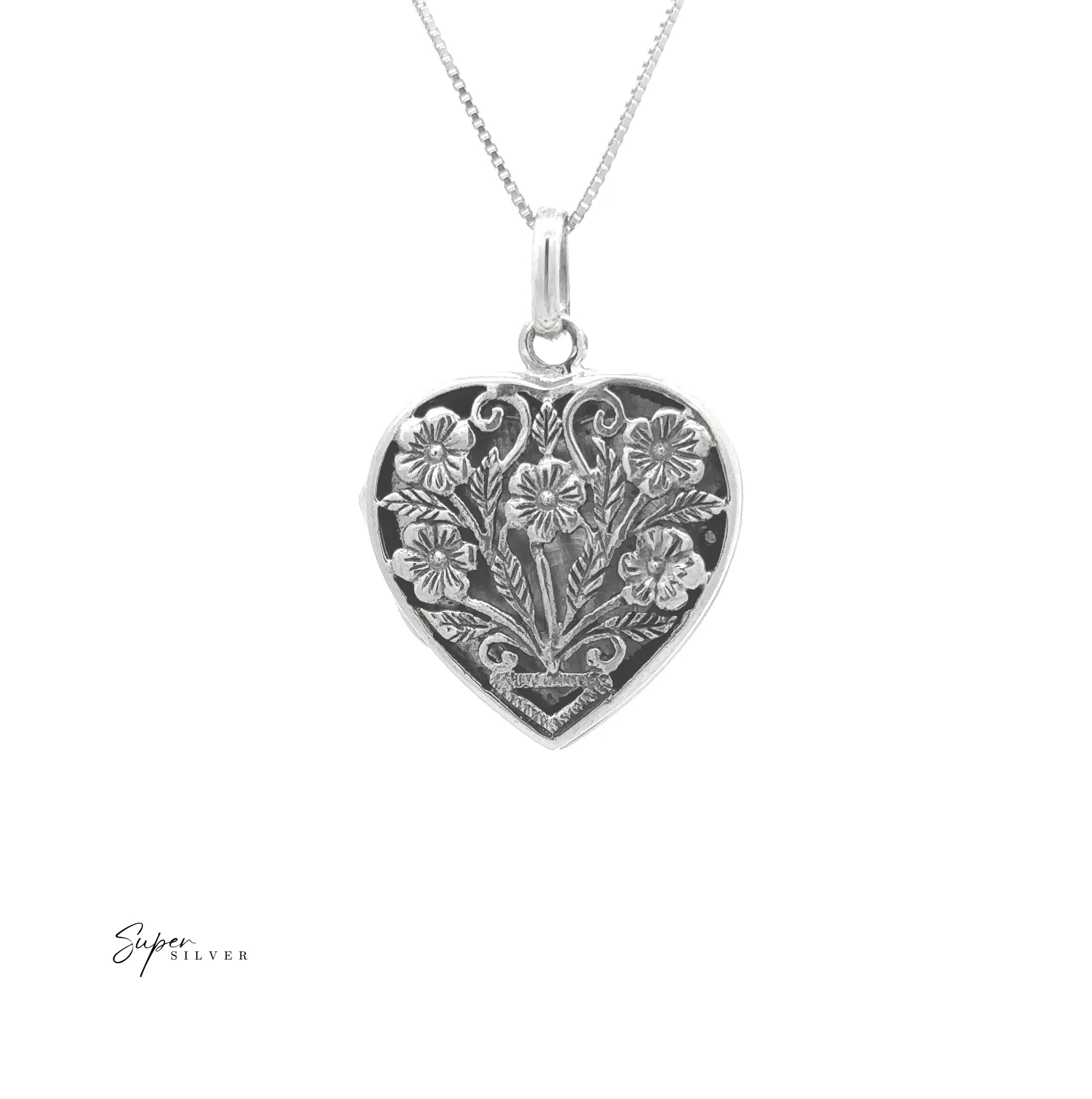 The Floral Heart Shaped Locket is a sterling silver heart pendant with intricate floral engravings on a delicate chain.