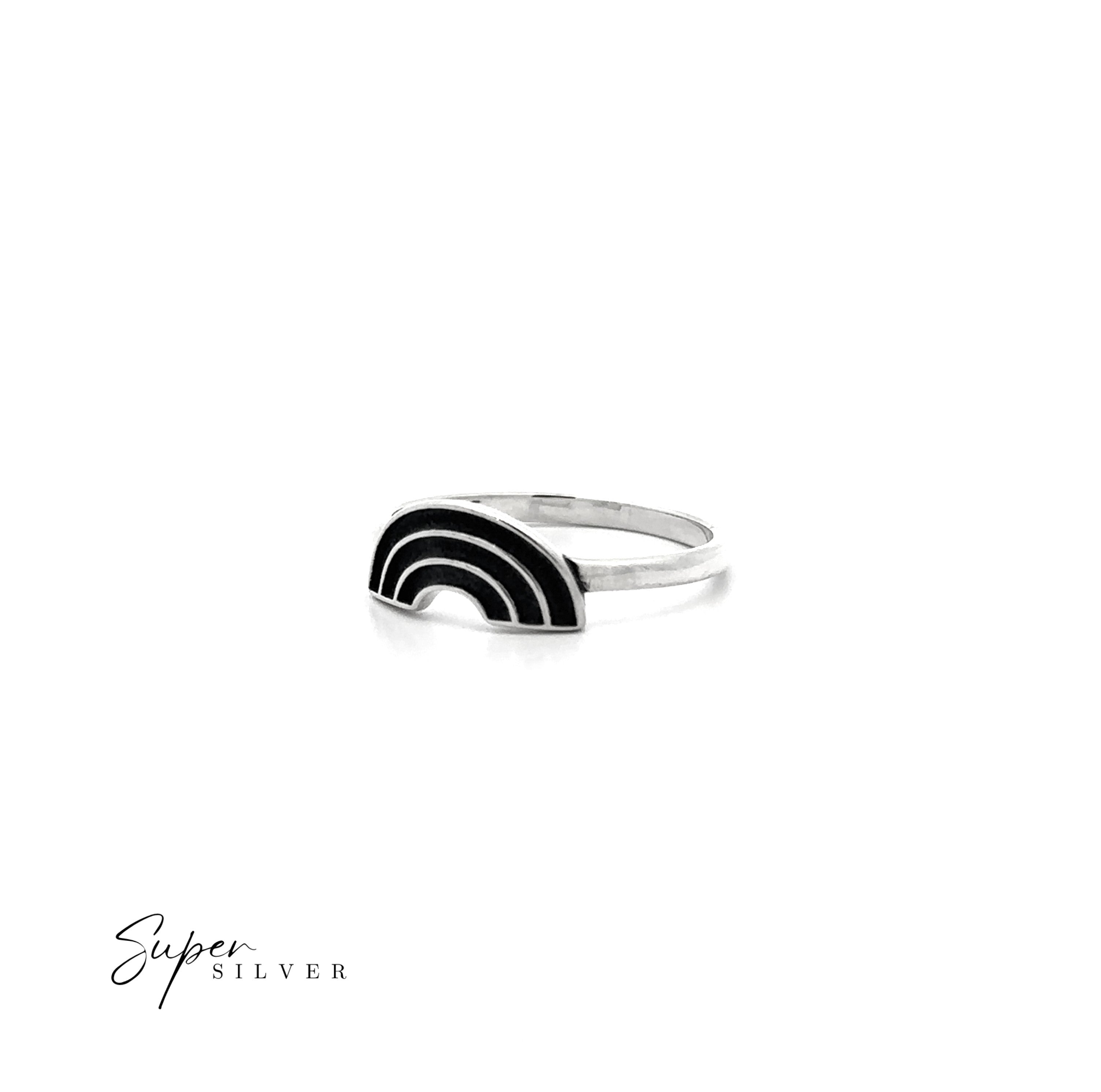 The Rainbow Ring is a sterling silver ring with a black and silver rainbow-shaped design on white. A symbol of love, this unique piece features the "Super Silver" logo in the bottom left corner.