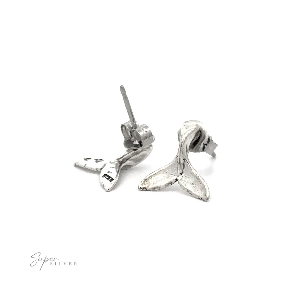 A pair of silver ocean-inspired Whale Tail Studs, perfect as a stylish accessory.