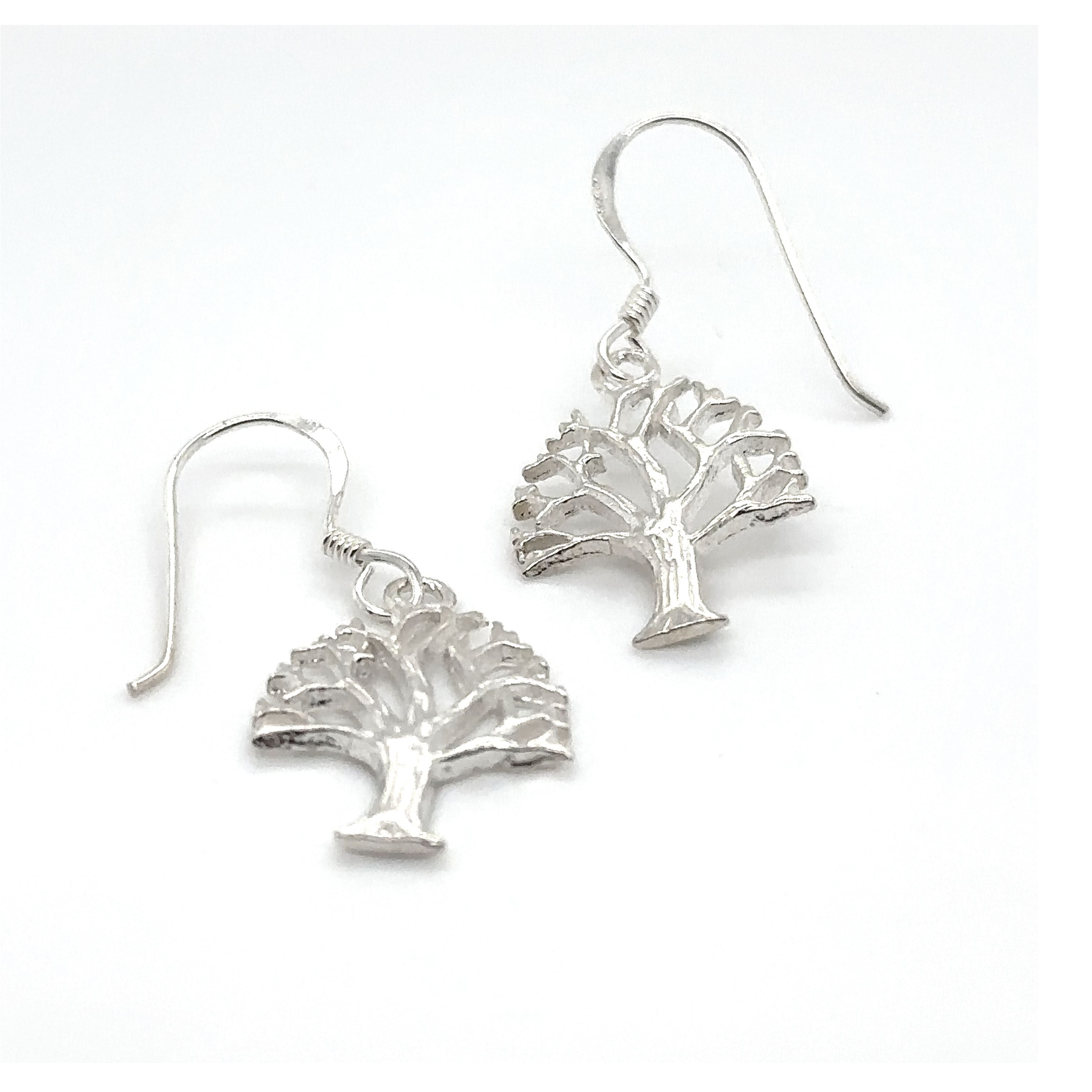 A pair of Super Silver Tree Of Life Earrings on a white background.
