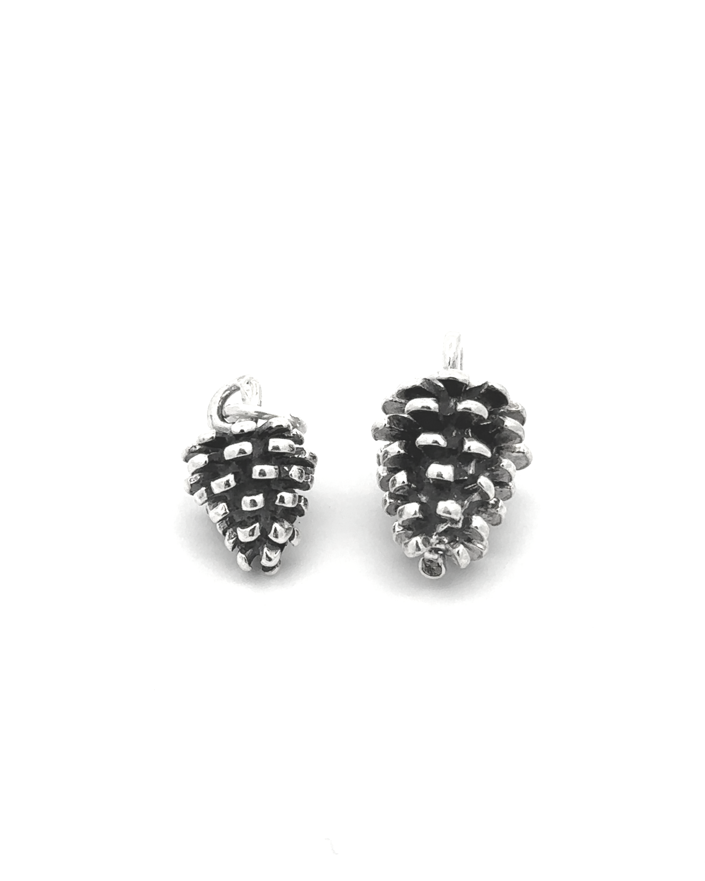 Two Pinecone Pendants, crafted from sterling silver, glisten on a white background—ideal for nature lovers.