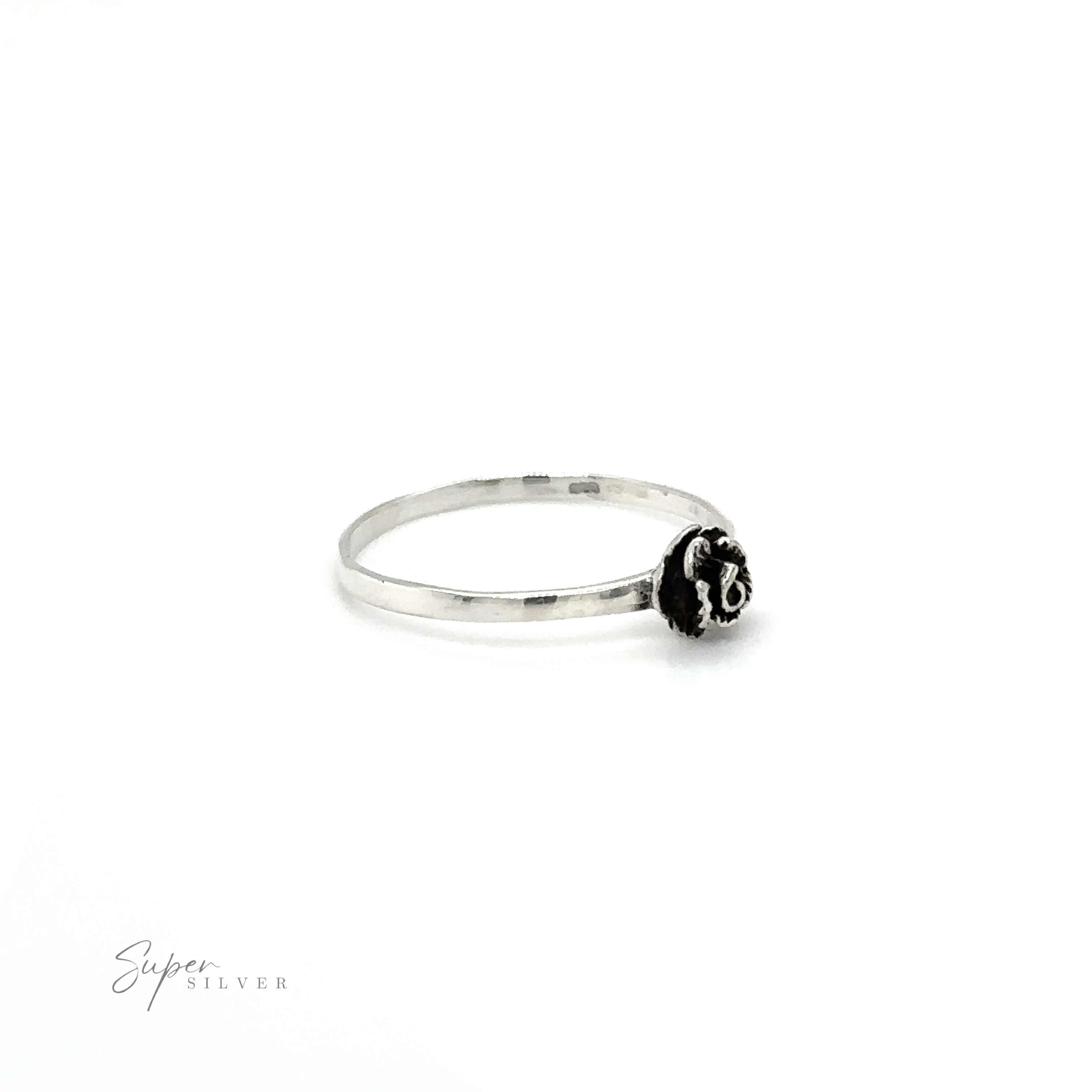 A Dainty Rose Ring with a black bead on it.