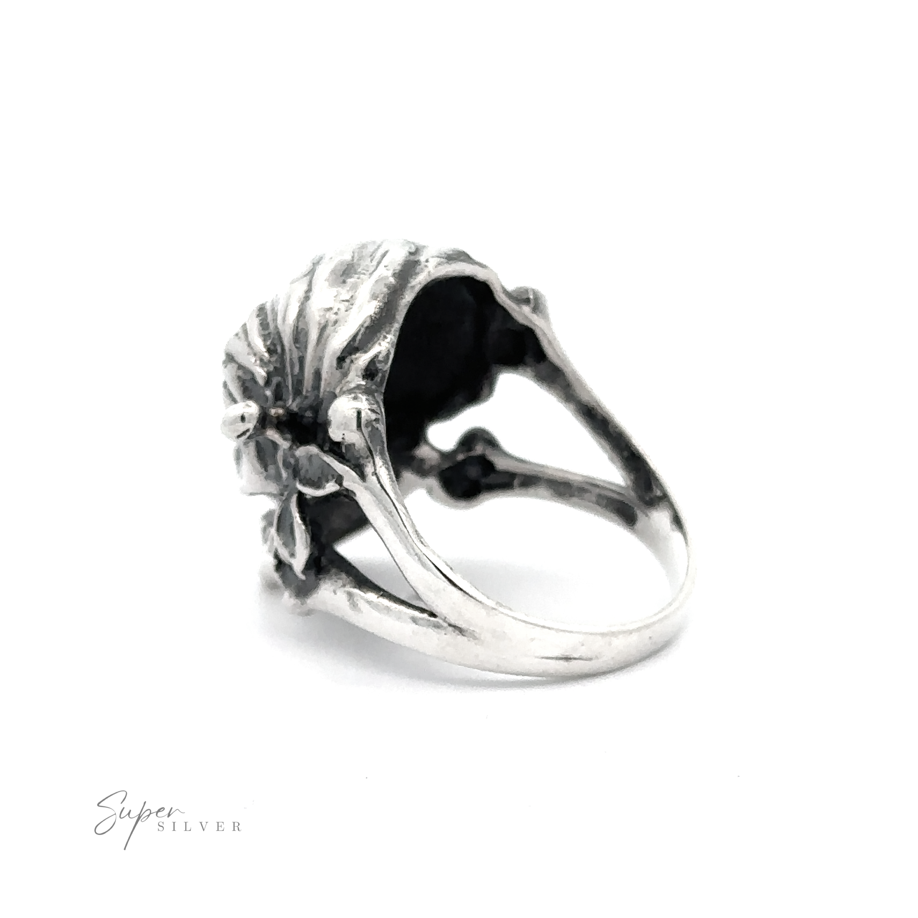 A Large Pirate Skull And Crossbones Ring with a detailed seashell design on a white background.