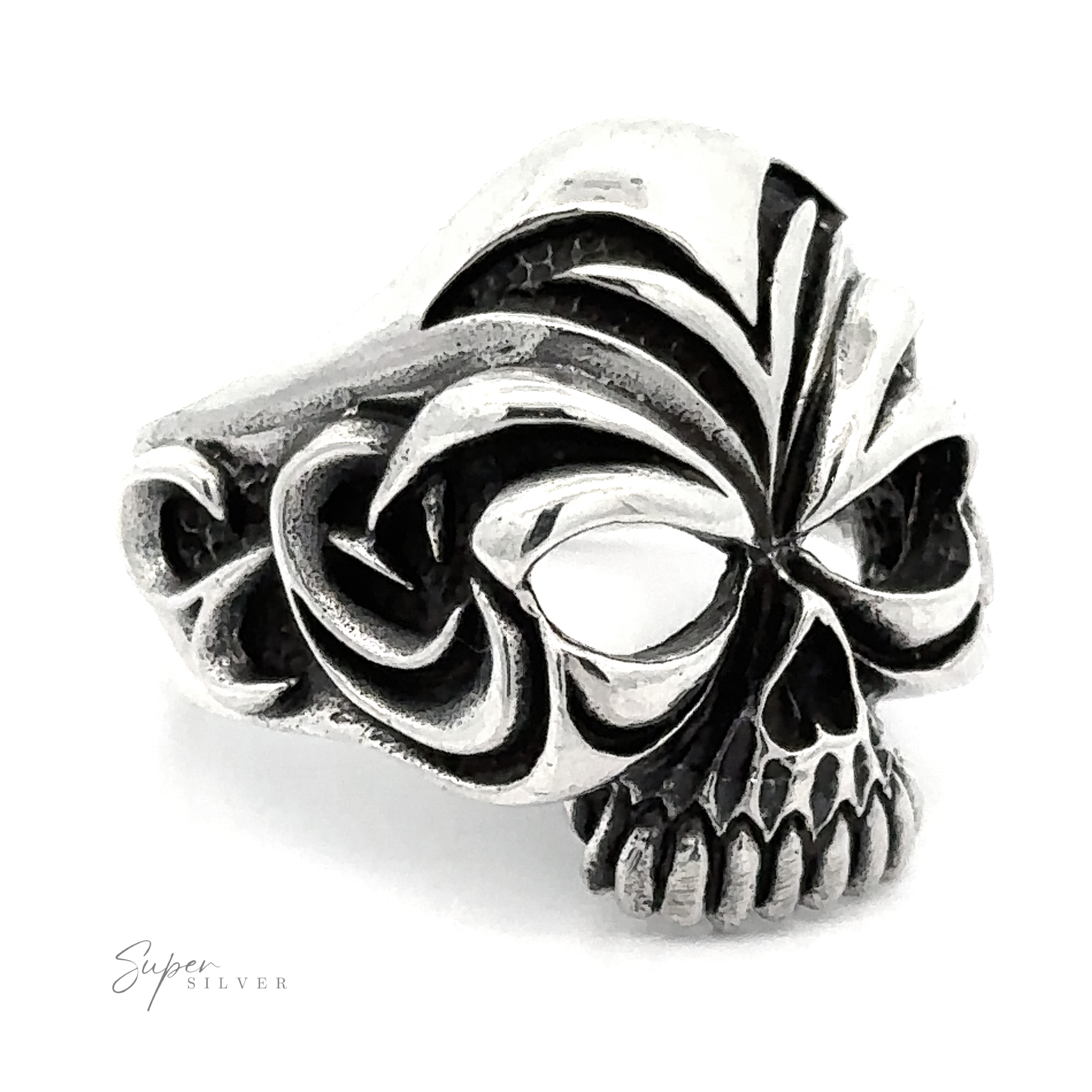 A detailed, Large Carved Skull Ring with intricate black engravings. The design features large eye sockets and prominent teeth at the front, embodying a bold style. The words "Super Silver" are visible in the lower left corner.