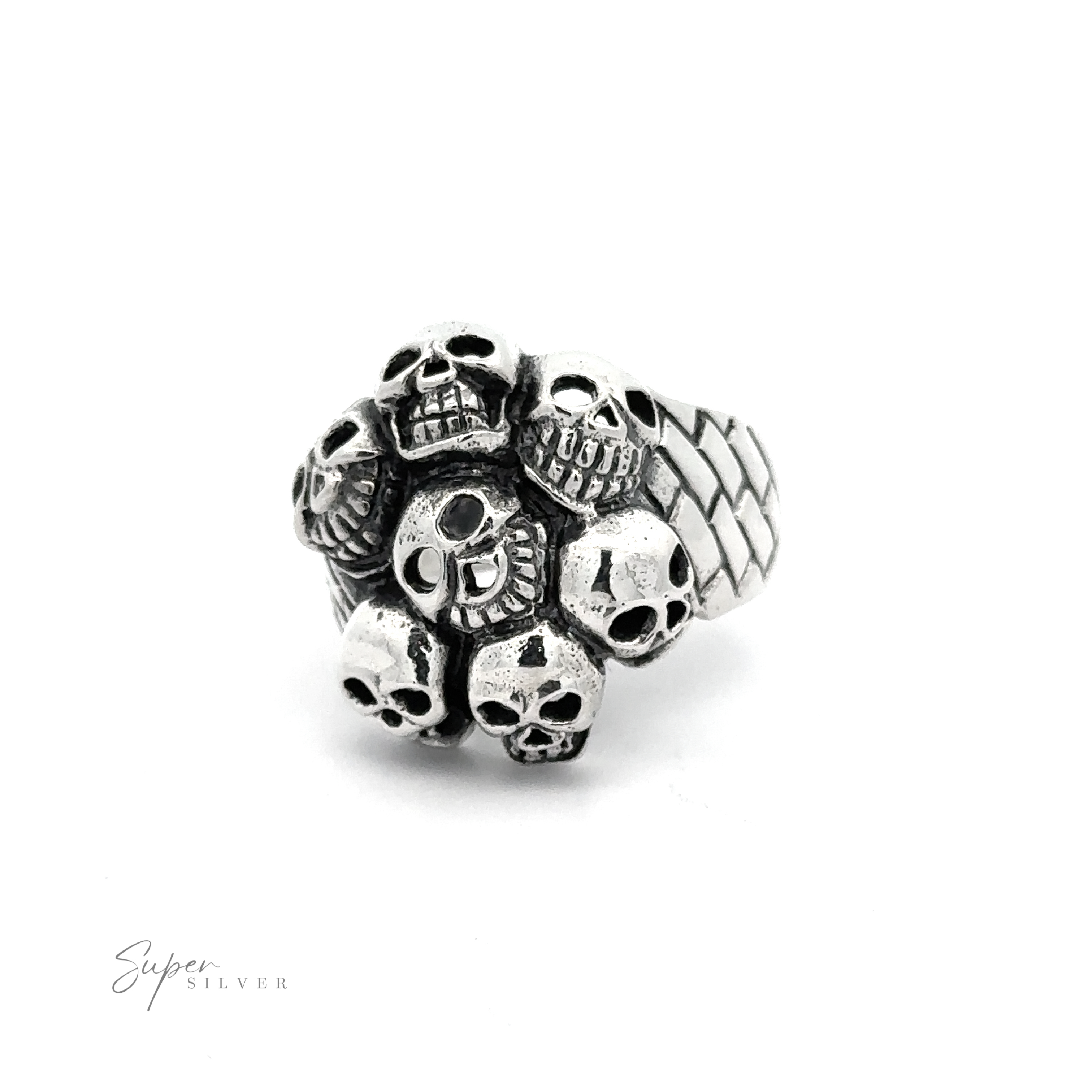 A Seven Grinning Skulls Ring featuring a cluster of small skulls on the band, displayed against a plain white background. The distinctive style and unique craftsmanship make it stand out. The brand “Super Silver” is noted in the bottom left corner.