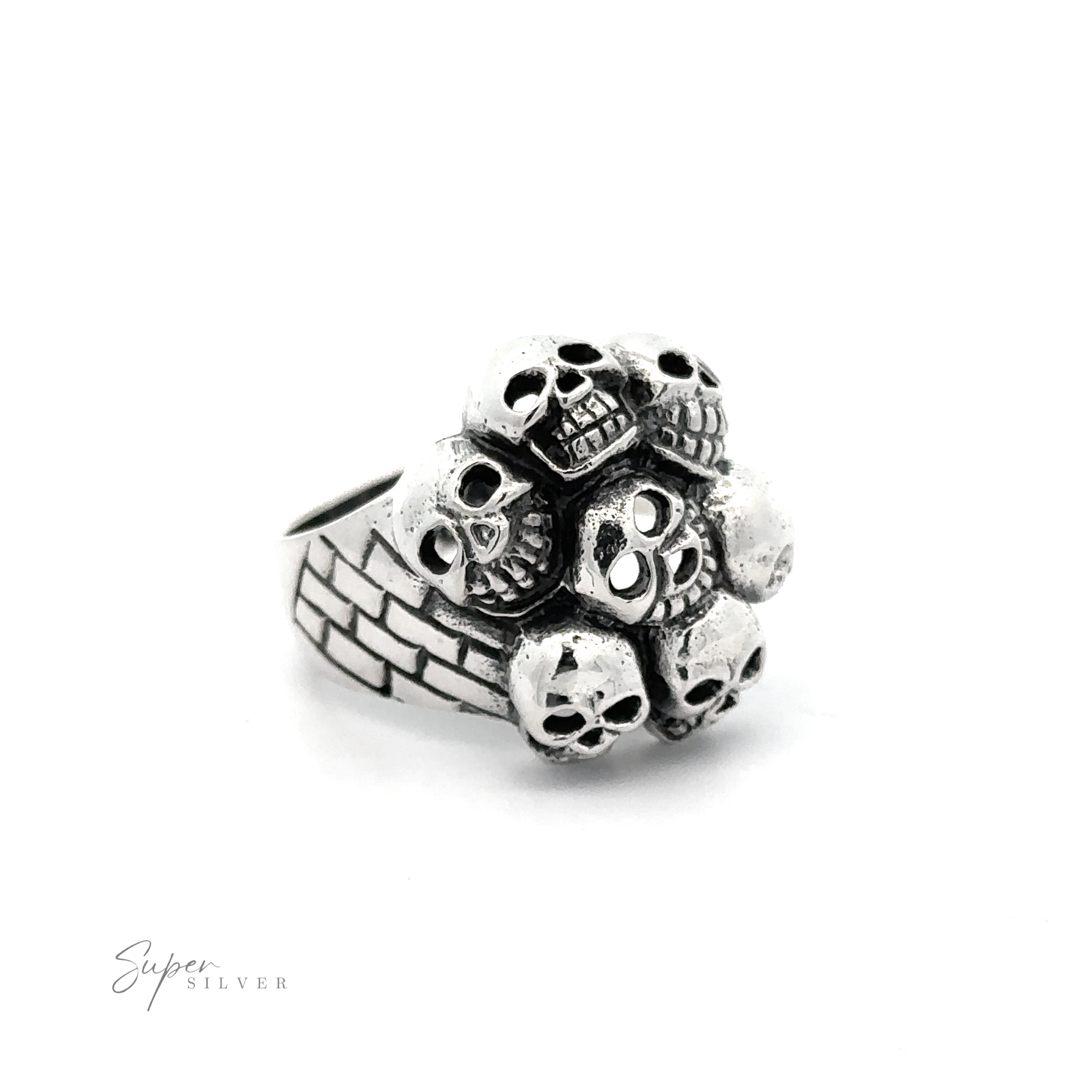 A Seven Grinning Skulls Ring showcasing an arrangement of small skulls on top. The band features a brick-like pattern, embodying unique craftsmanship and distinctive style.