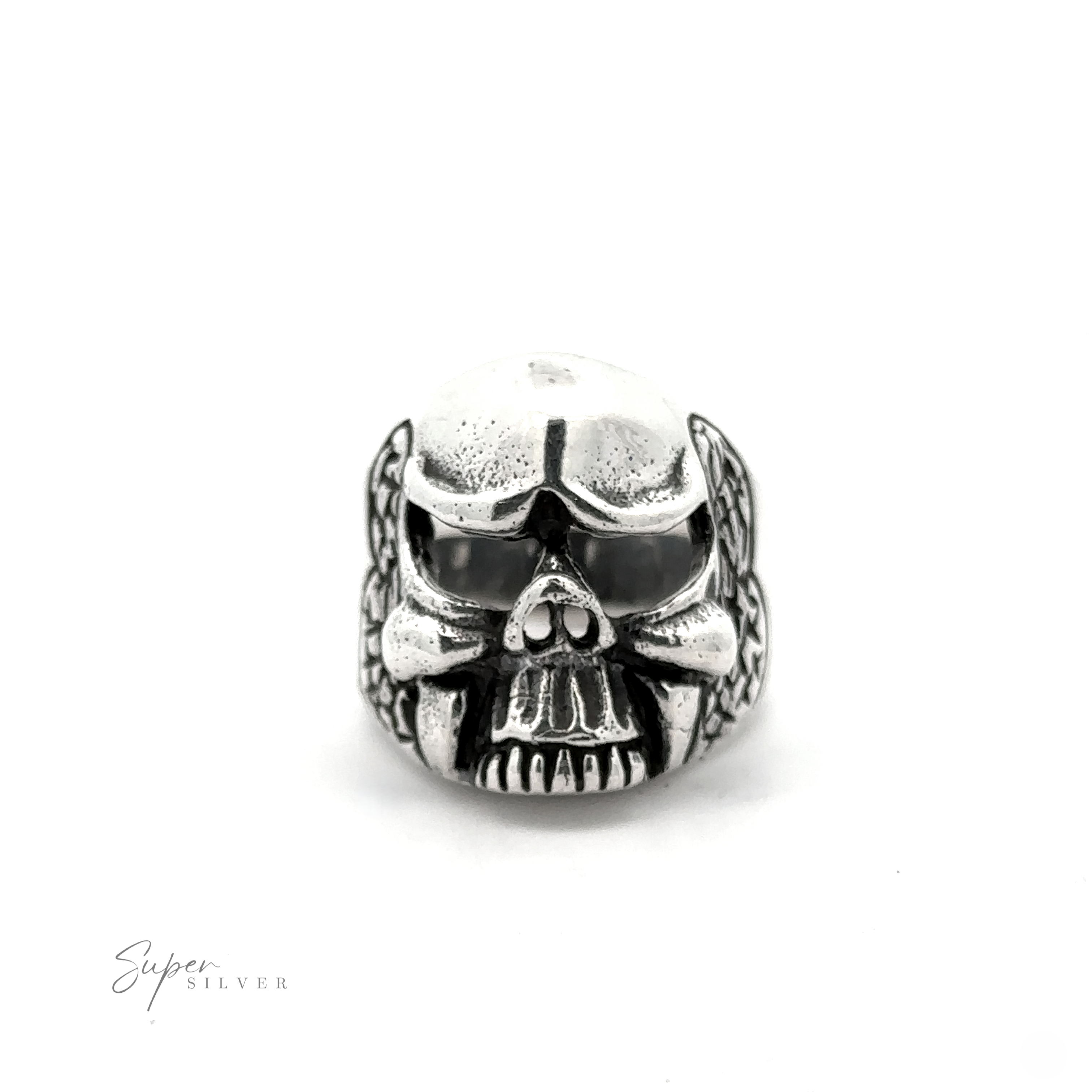 The Skull Statement Ring, crafted from .925 Sterling Silver, features a skull design with intricate engravings. Ideal for an edgy look, it showcases darkened areas that accentuate the eyes, nose, and mouth. The brand name "Super Silver" is printed in the bottom left corner.