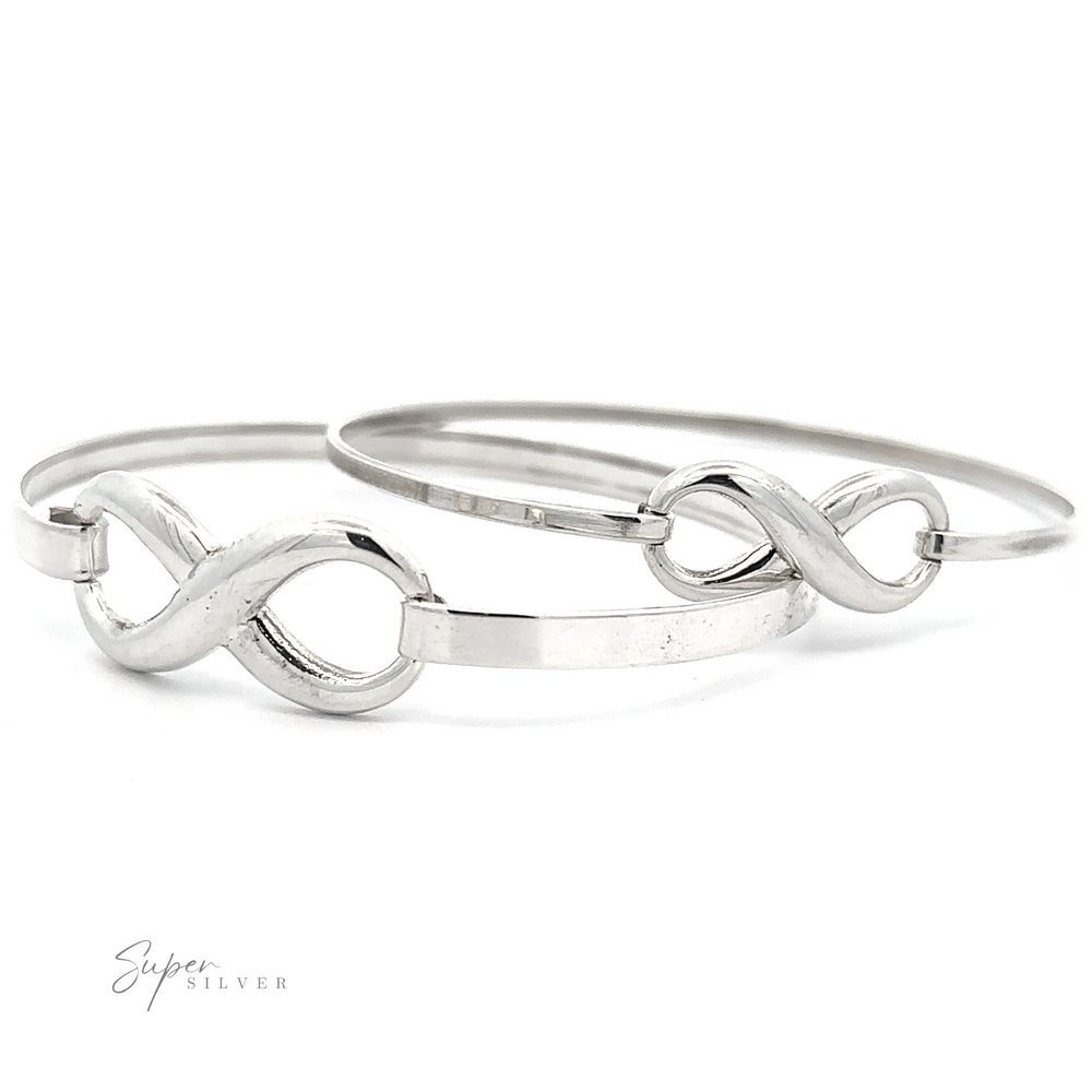 Two Infinity Bracelets with elegant latch clasps are positioned side by side on a white background. The logo 