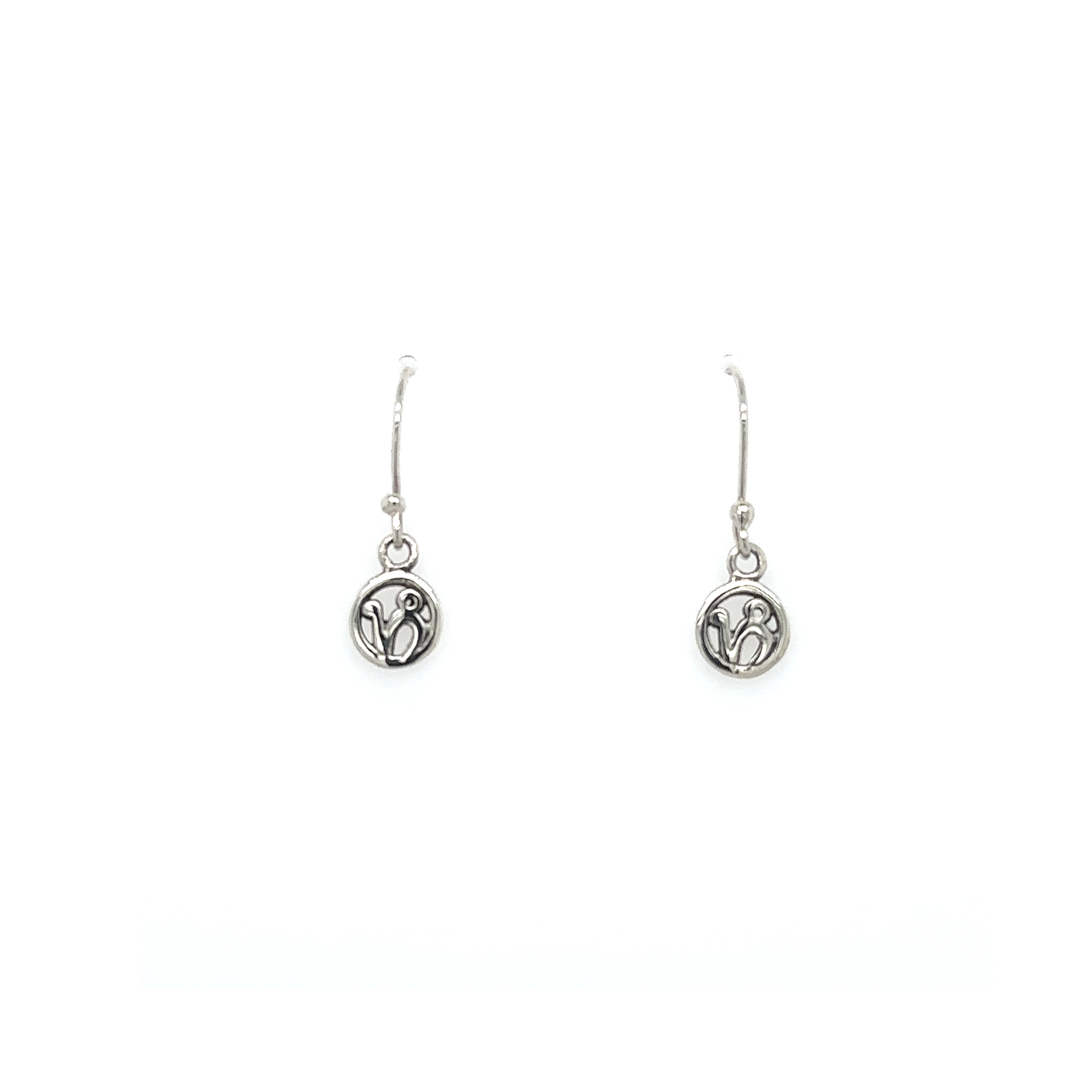 A pair of Super Silver Capricorn Zodiac Earrings with a small coin featuring the Capricorn zodiac symbol.