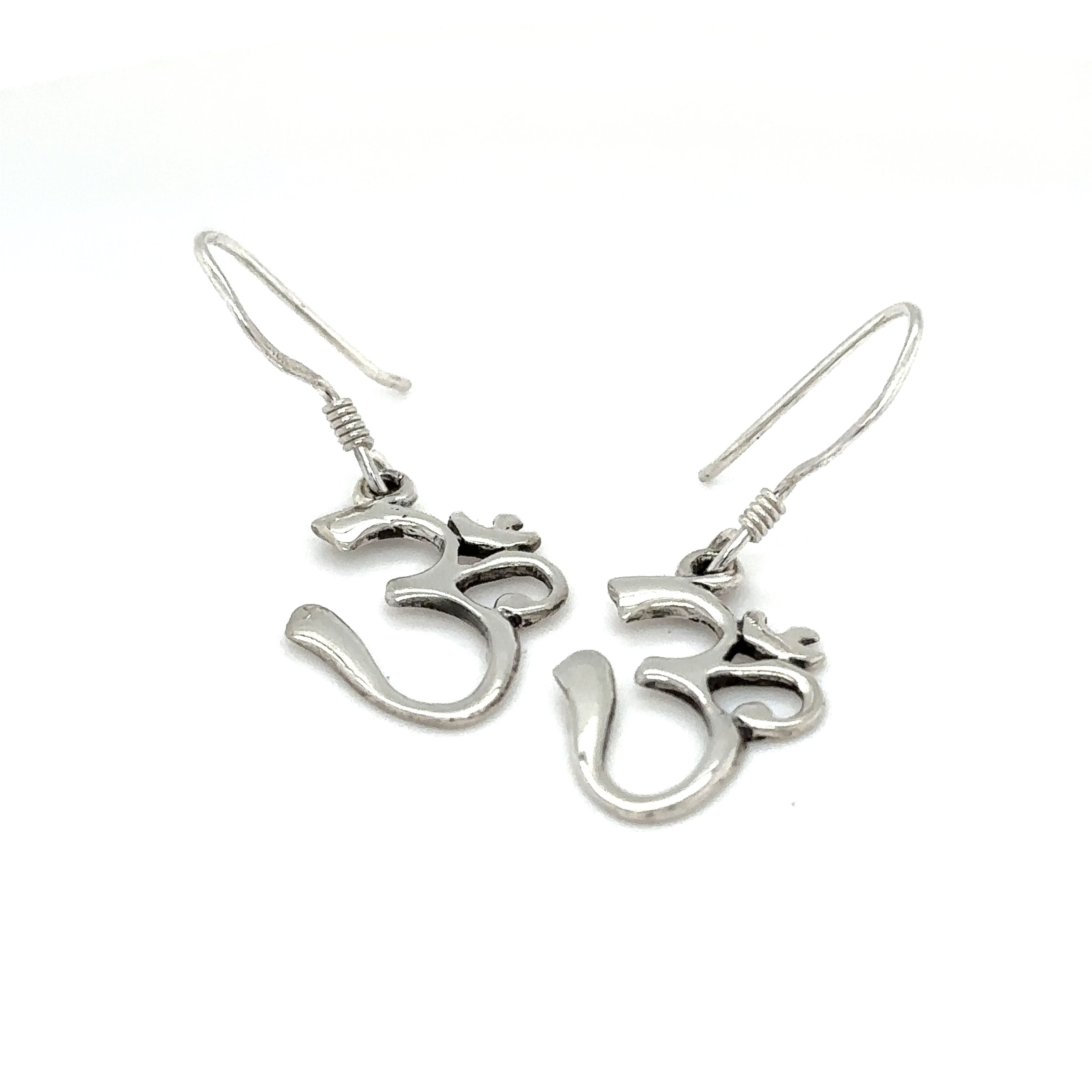 A pair of Simple Om Earrings by Super Silver on a white background.
