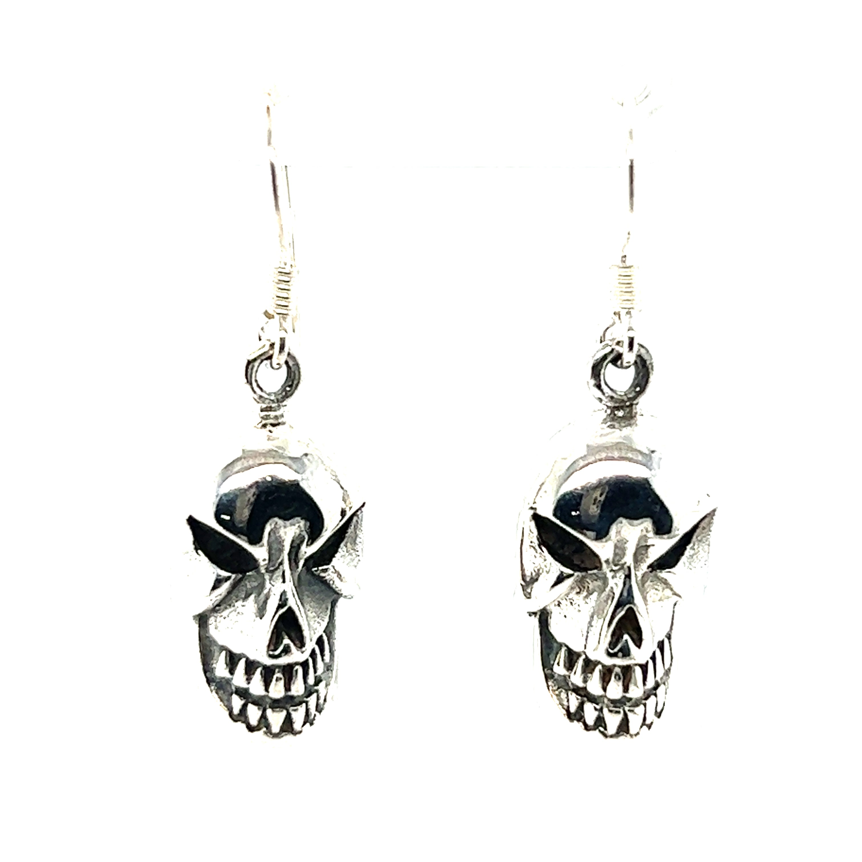 A pair of Super Silver skull earrings on a white background.