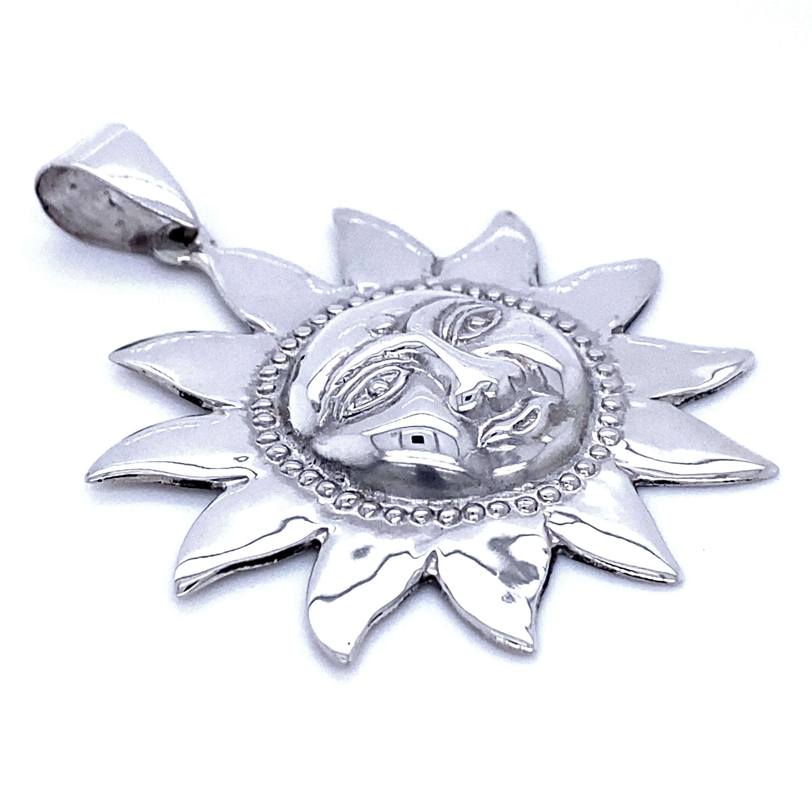 A Sun God Pendant with a detailed face in the center, featuring sun rays radiating outward.
