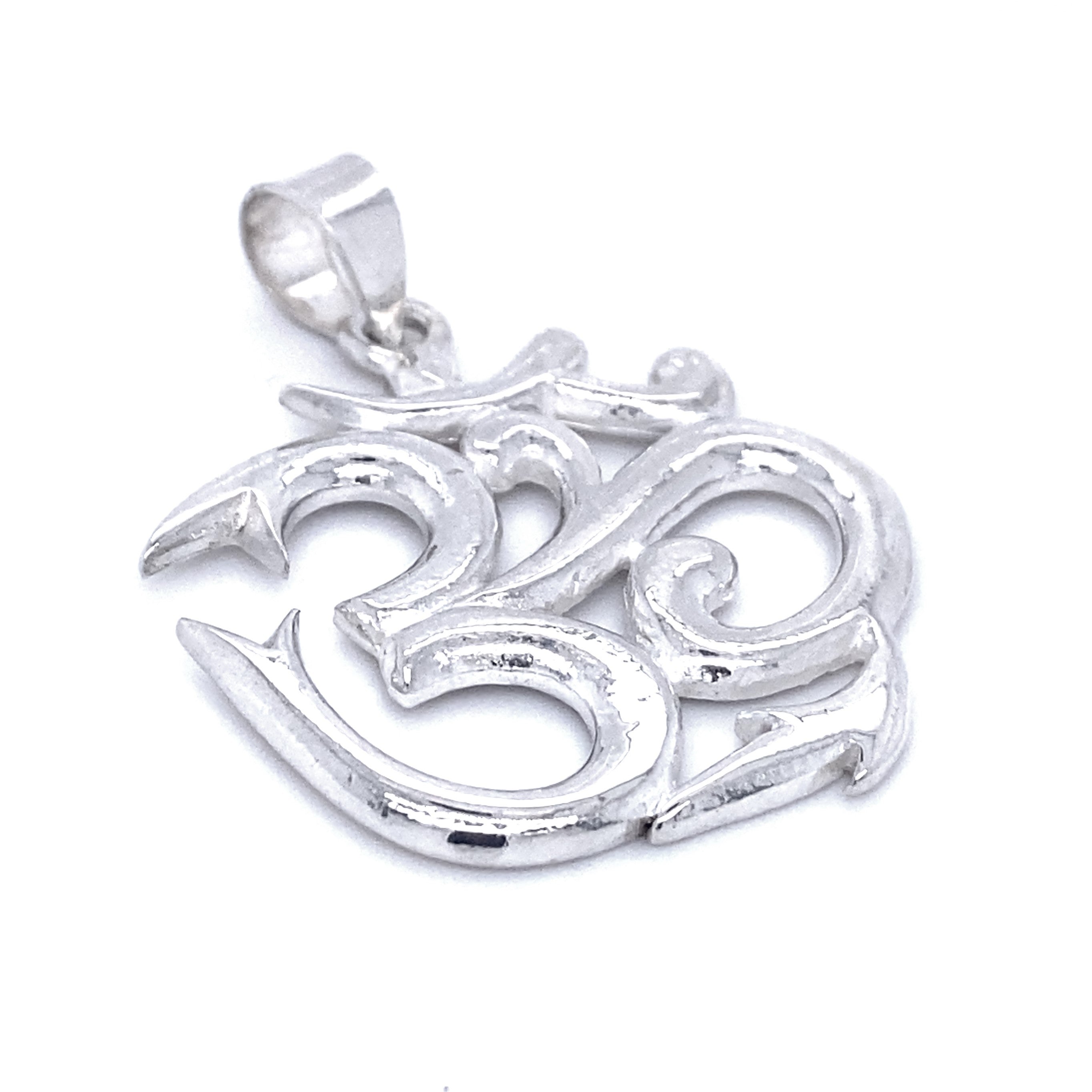 Statement Om Pendant in the shape of the Om symbol with a glossy finish, designed for a necklace or chain. A beautiful tribute to the Hindu symbol, this Statement Om Pendant brings both elegance and spiritual significance.