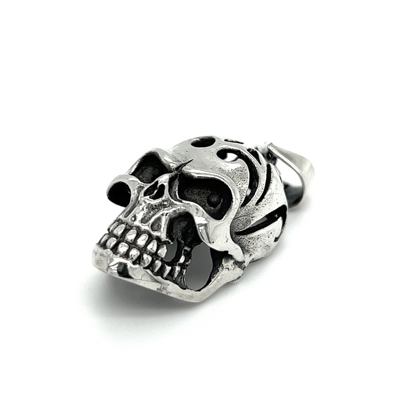 
                  
                    A distinctive Super Silver skull pendant with an oxidized finish and swirl design, displayed on a white background.
                  
                