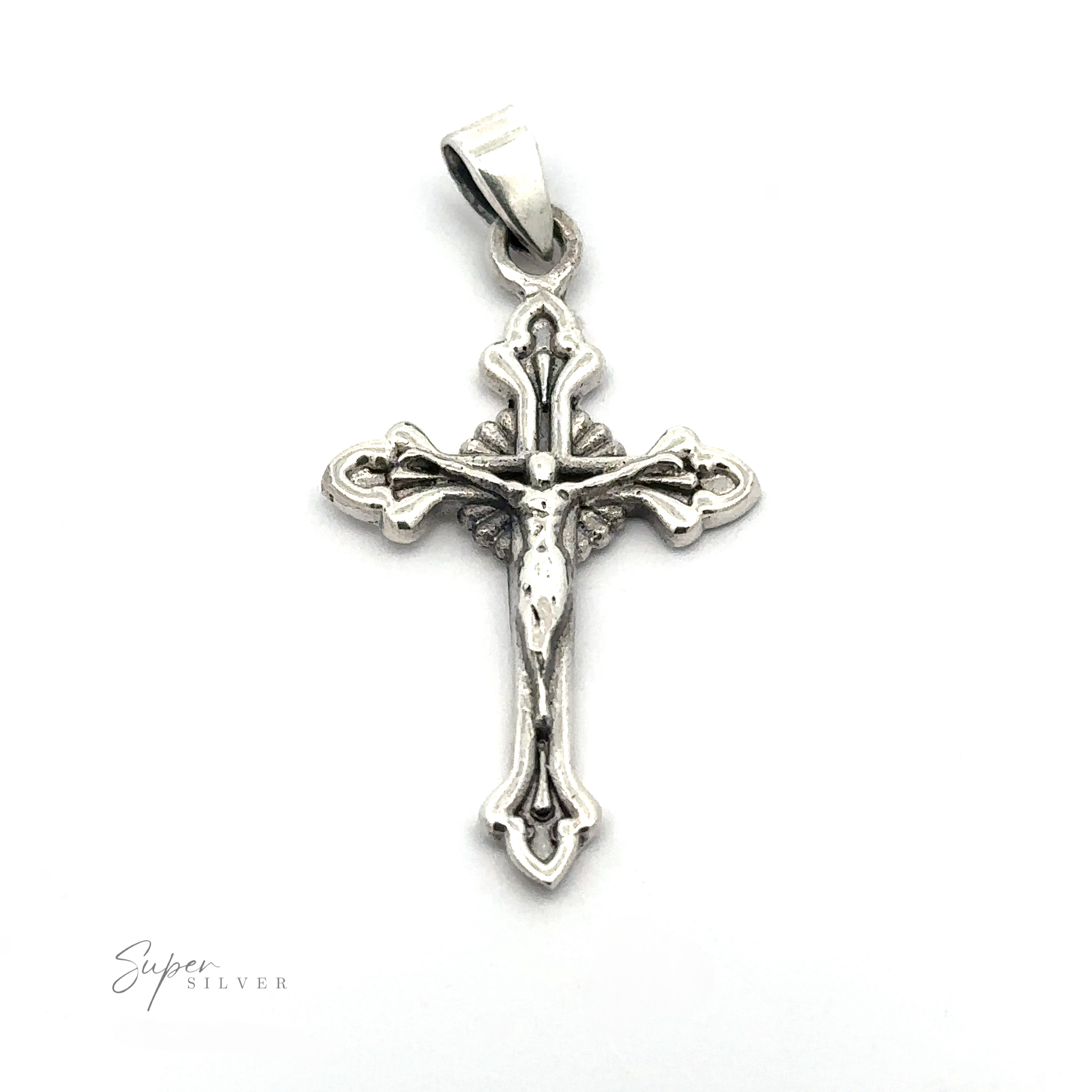 A vintage Crucifix Charm featuring a detailed figure of Jesus crucified, with ornate designs on the sterling silver crucifix, mounted on a polished bail.