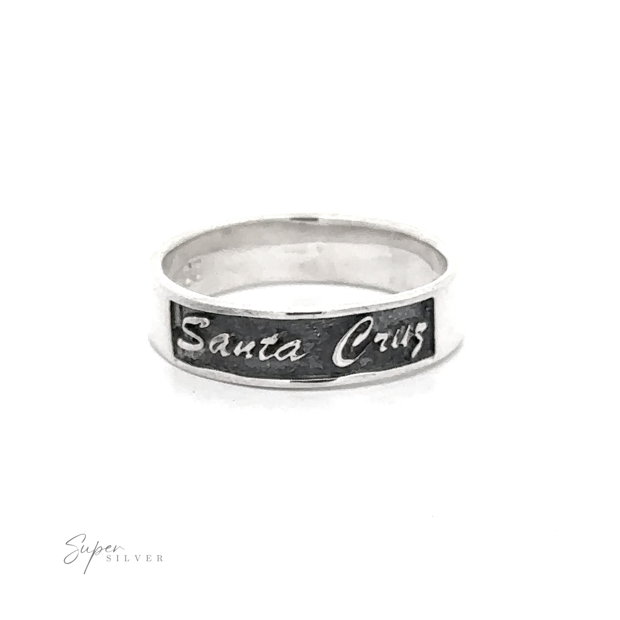 A flat band ring in .925 Sterling silver with "Santa Cruz" engraved in black lettering would be replaced by Sterling Silver Santa Cruz Ring With Cursive Text.