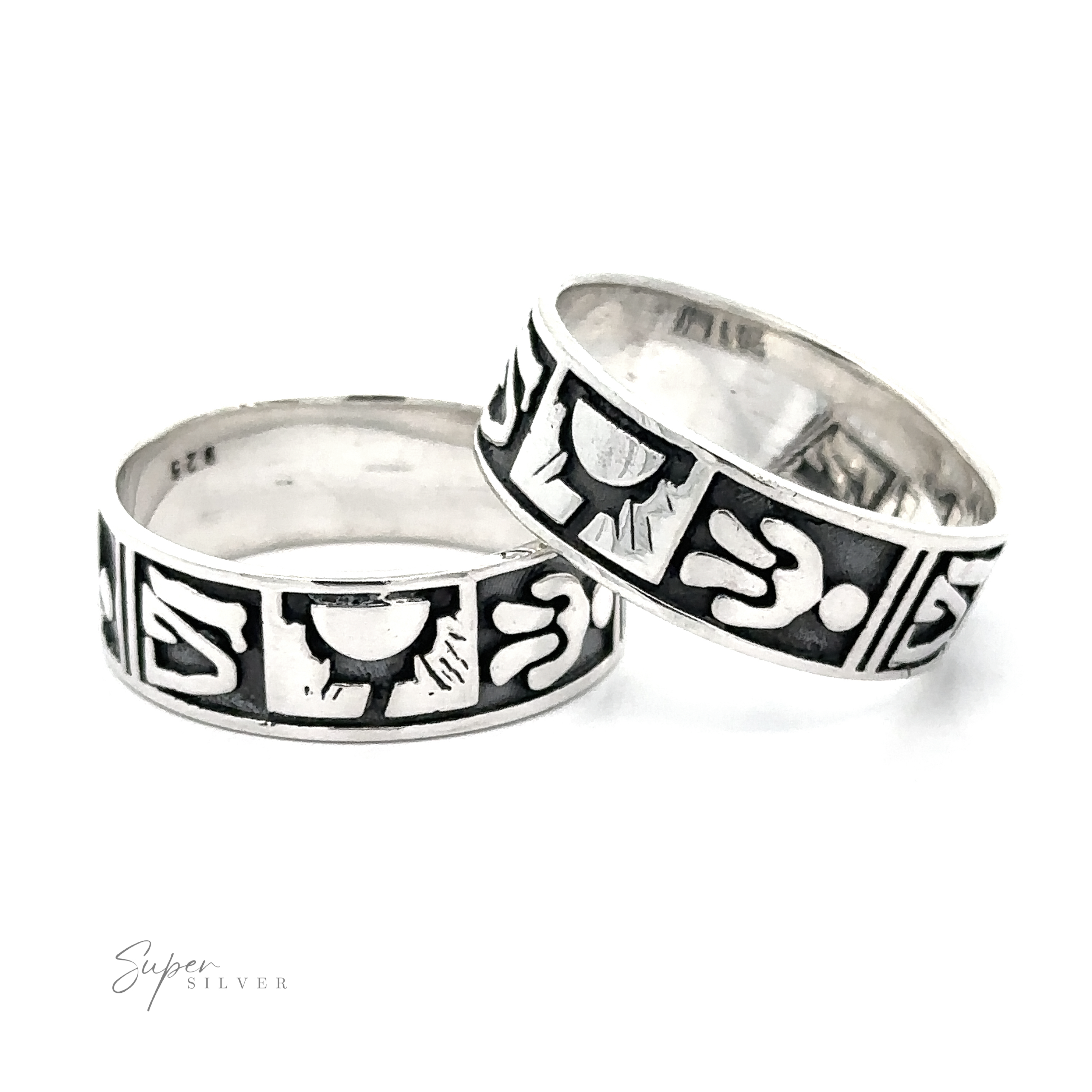 Two Petroglyph Silver Bands with tribal patterns reminiscent of ancient rock carvings on a white background.