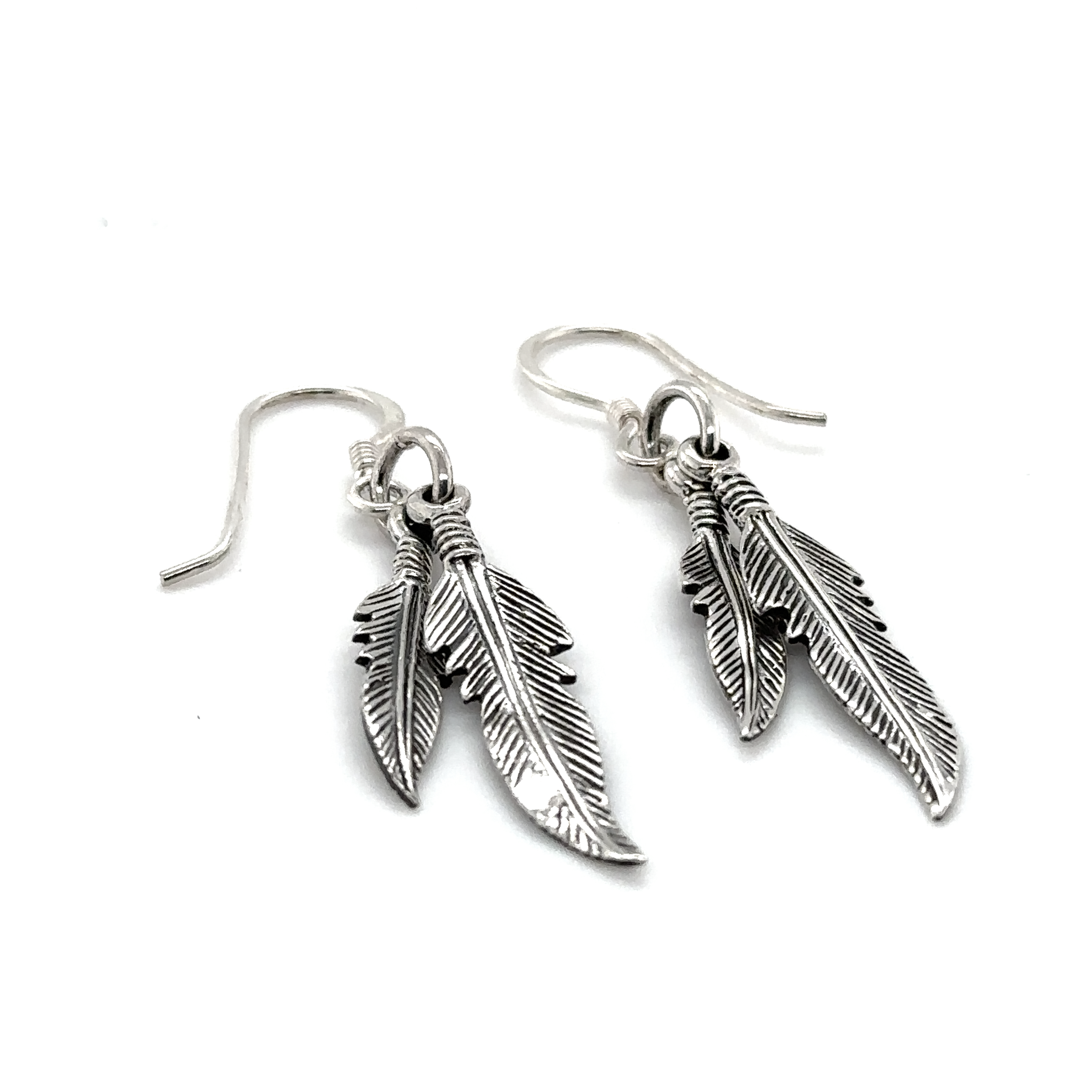 A pair of Super Silver Double Feather Earrings with french hook on a white background.