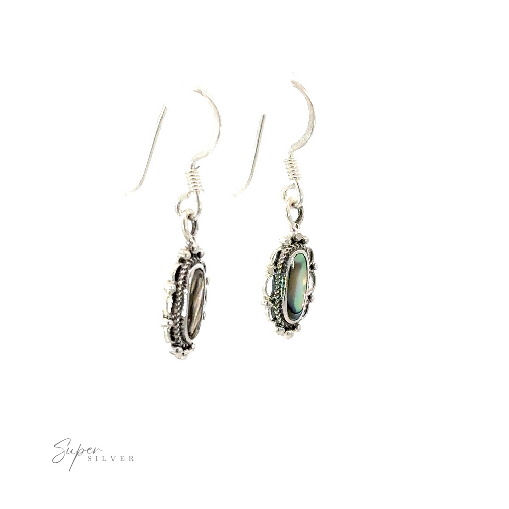 
                  
                    Dainty Vintage Inspired Oval Inlaid Stone Earrings with a stone in the middle.
                  
                