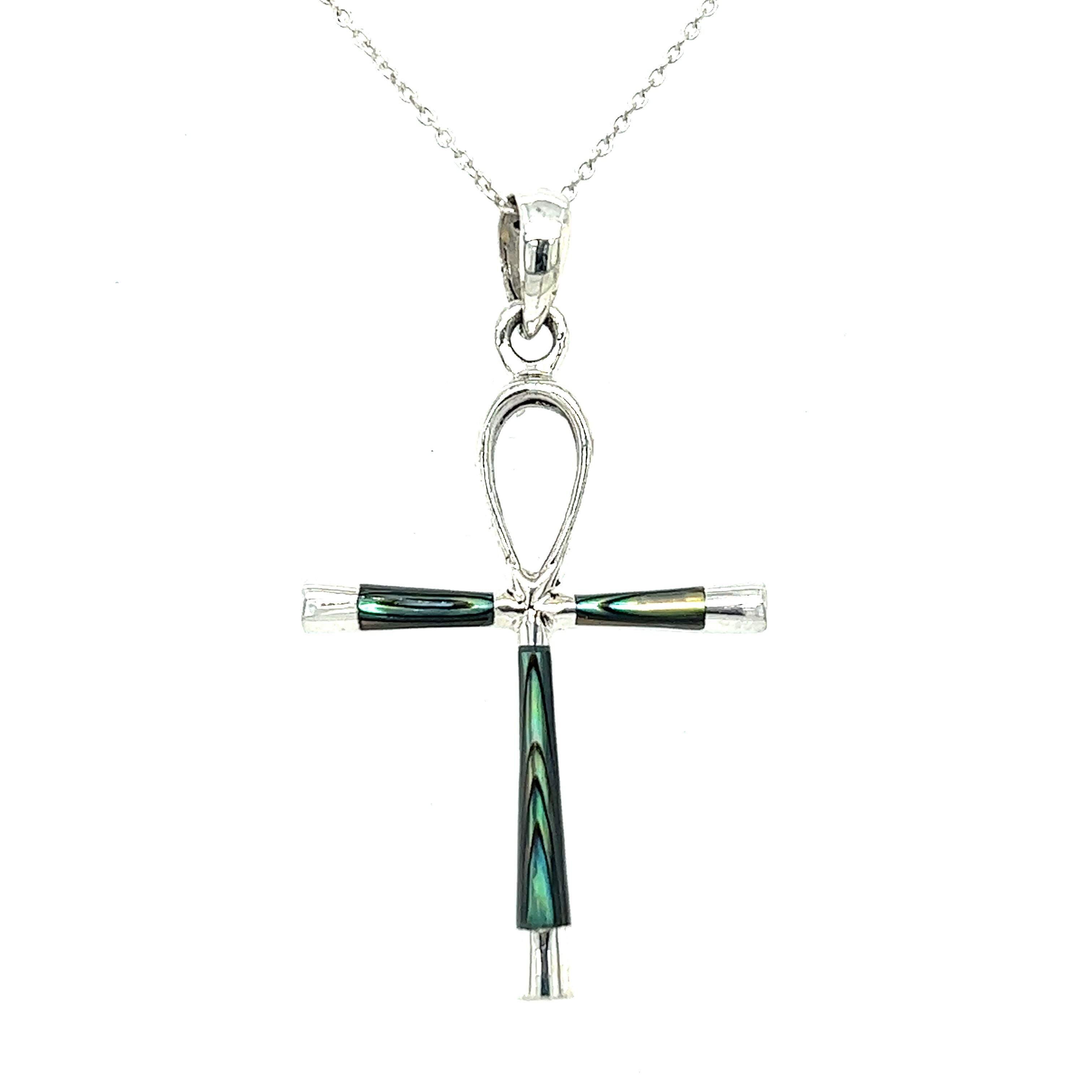 This statement piece features an Inlay Stone Ankh Pendant adorned with black and green stones, elegantly displayed on a Super Silver chain.