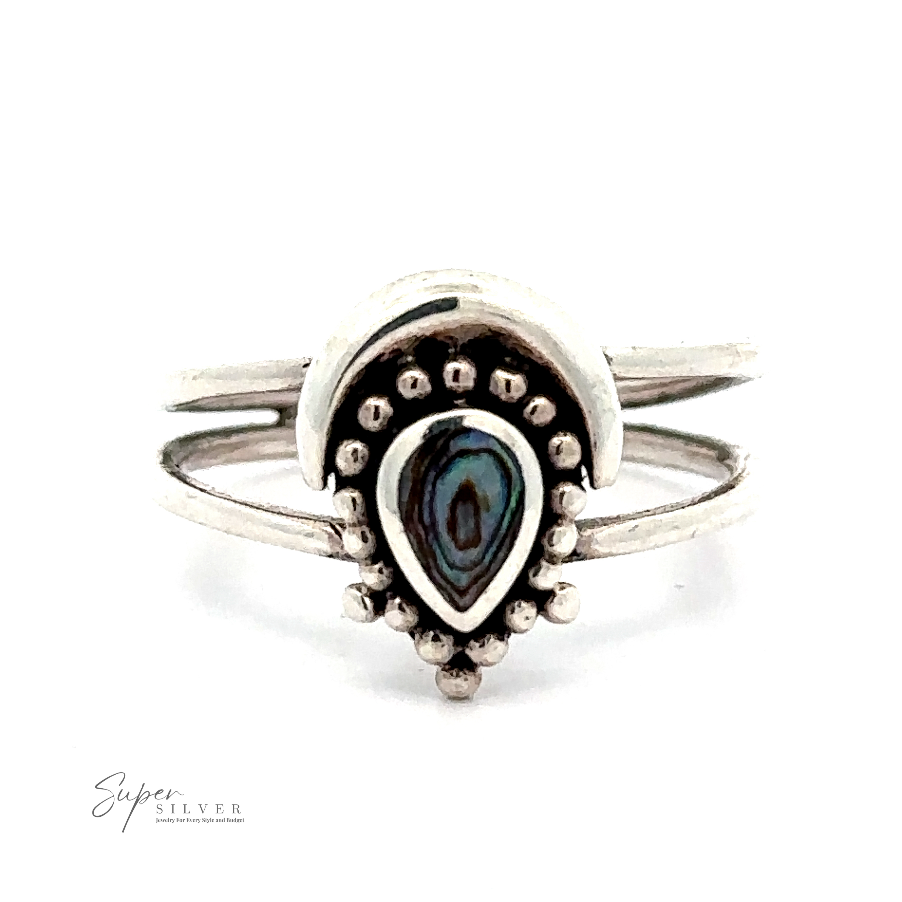 A Bali-inspired silver ring featuring a teardrop-shaped centerpiece with an iridescent stone in the middle and small silver dot accents around it. Branding "Teardrop Ring With Inlaid Stone and Crescent Moon" visible in the corner.